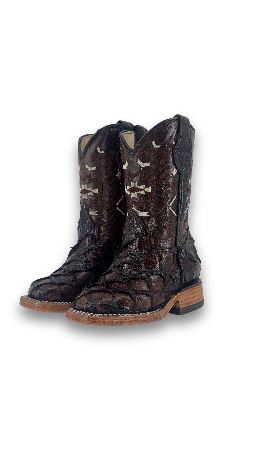 The Clone Fish Pirarucu Aztec Kids Boot comes in all brown, featuring a square toe, pirarucu vamp, embroider shaft, leather sole, and rubber heel.