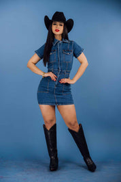 This denim collared short-sleeve button-down mini dress has a relaxed fit with a medium wash, side pockets, and chest pockets.