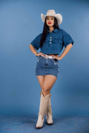 This mid-rise mini skirt features embroidered pocket details