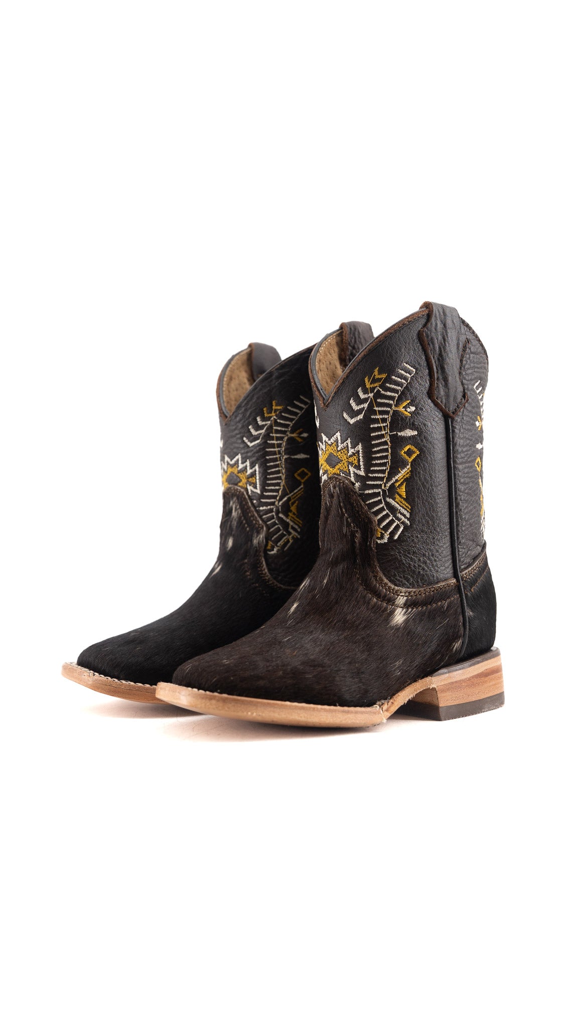 Pair of black and brown cowboy boots with intricate designs on a white background
