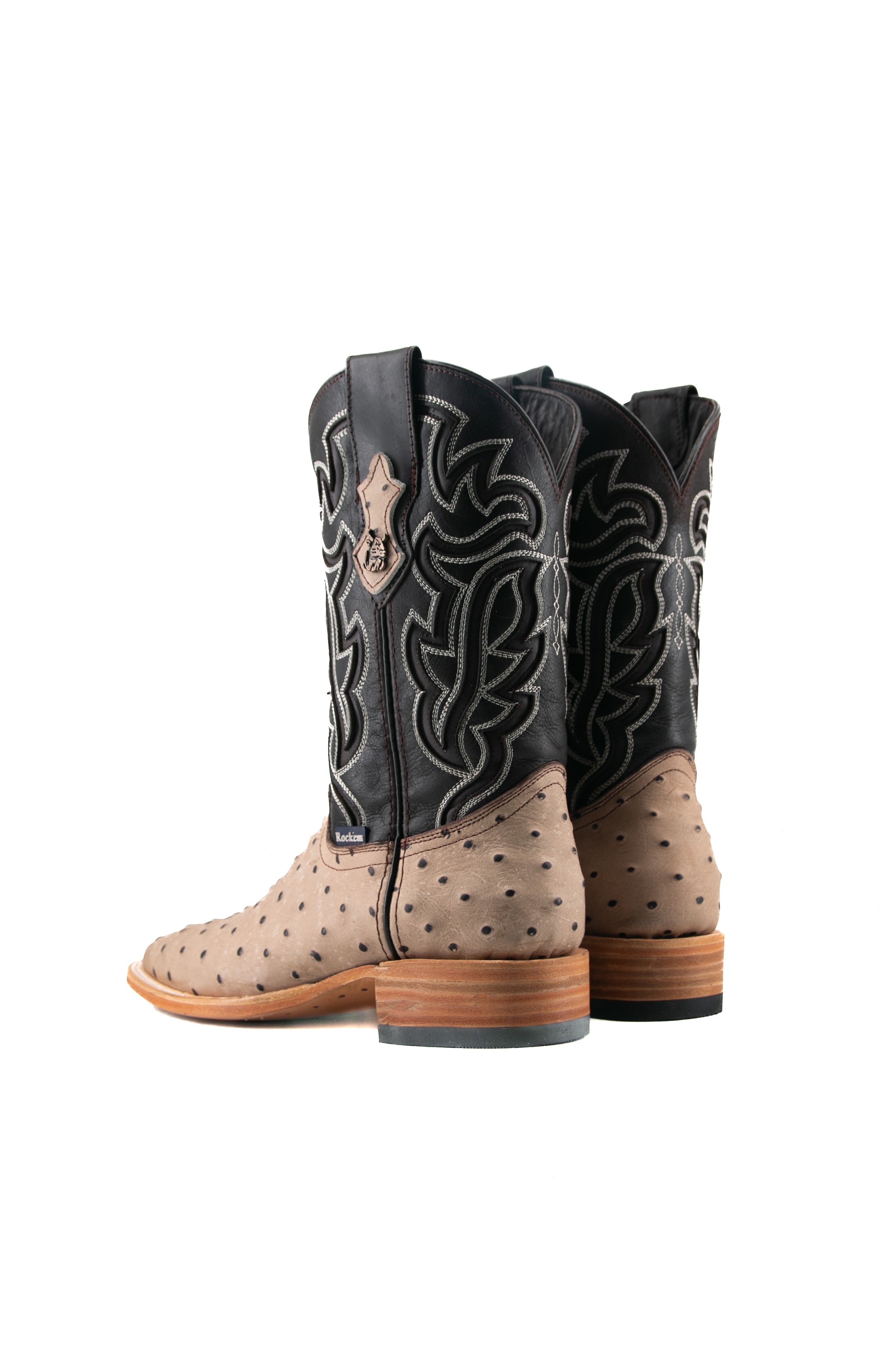 Back view of the Bruce ostrich cowboy boot in Desert featuring a bumpy vamp, flame inlays on a dark shaft, square toe, leather sole, and rubber heel.