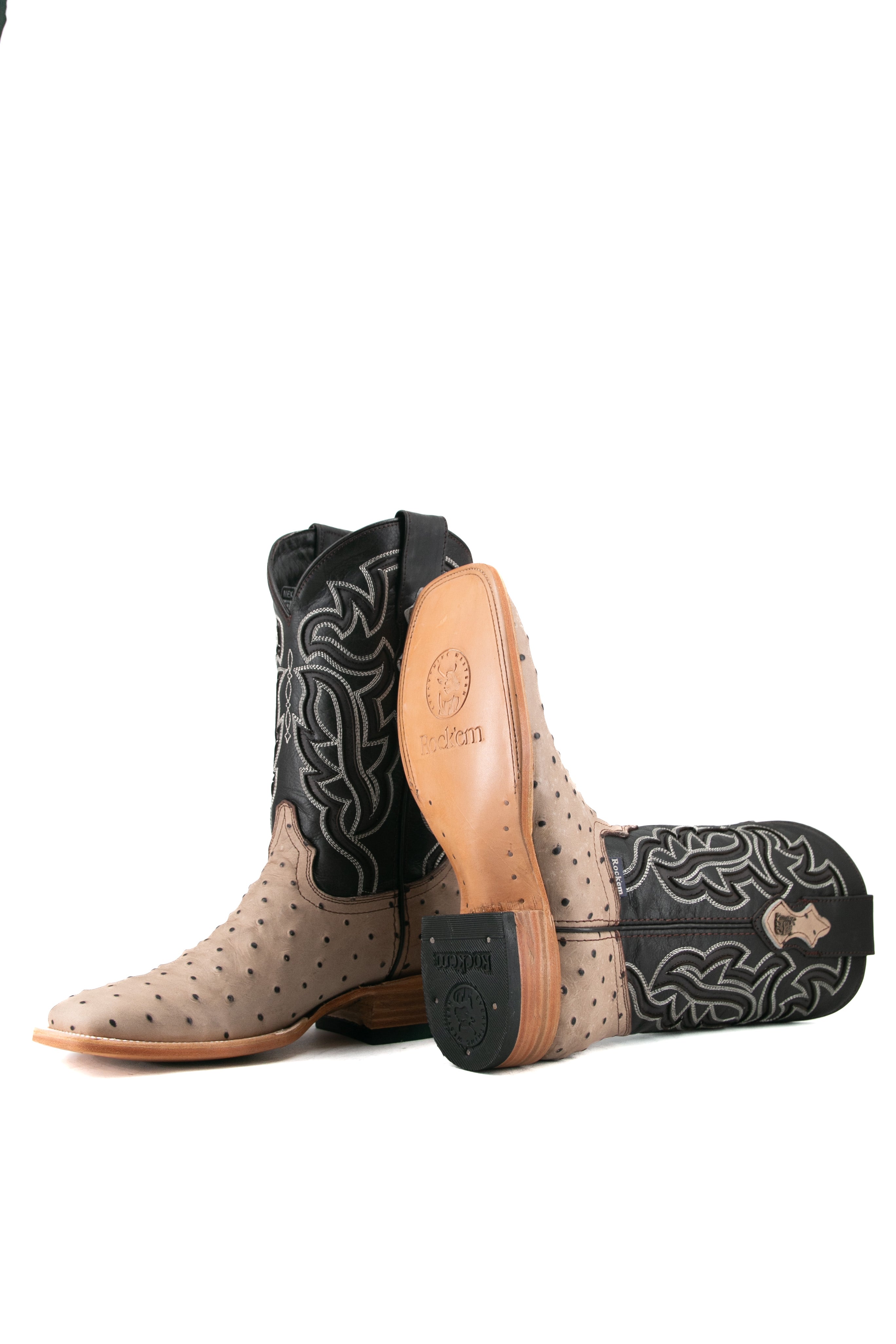 Side view of the Bruce ostrich cowboy boot in Desert showcasing the leather sole and rubber heel.