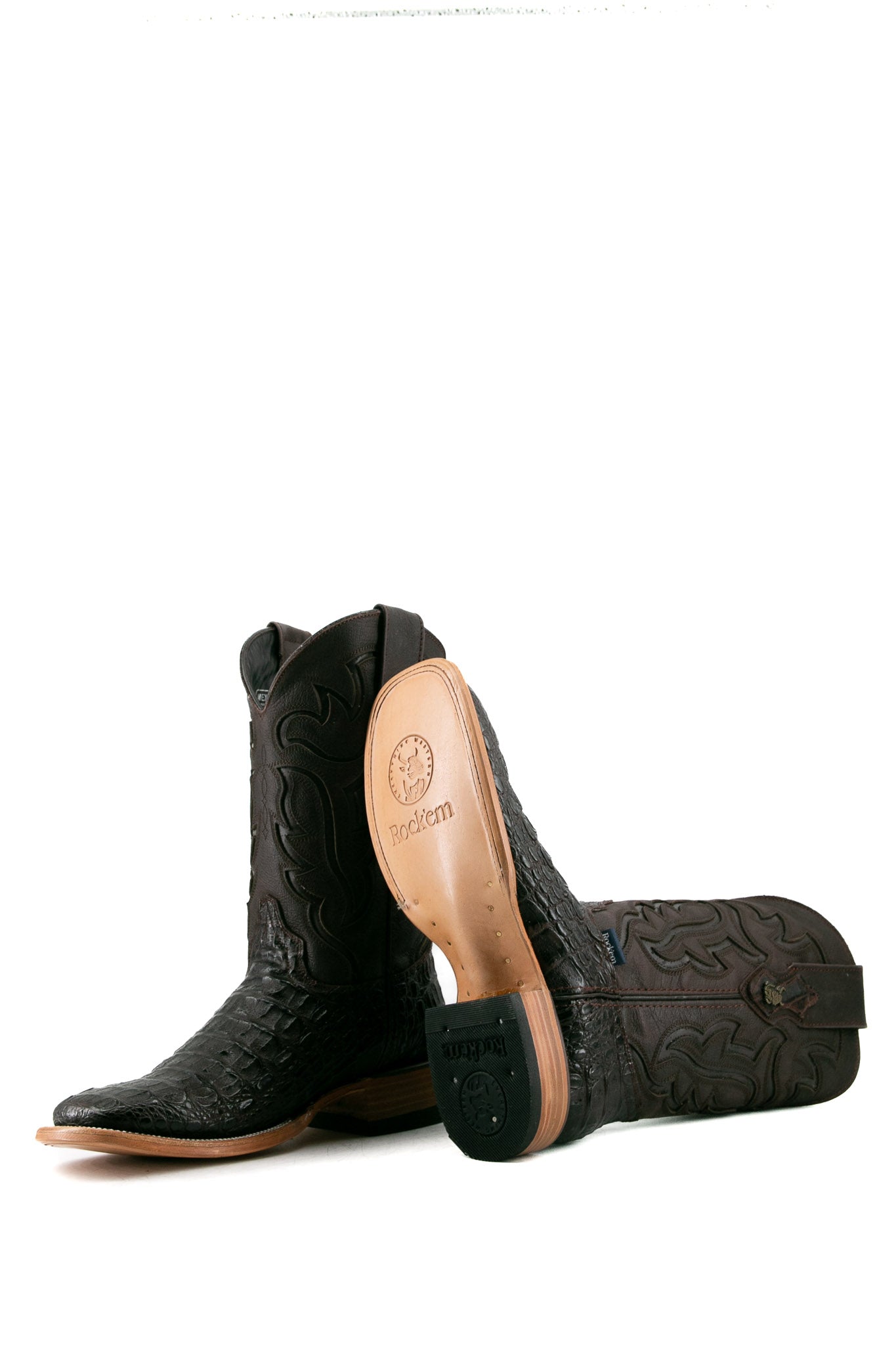View of brown Cody Caiman cowboy boots in genuine leather, featuring a square toe, caiman print vamp, brown embroidered shaft, tan leather sole, and rubber heel.