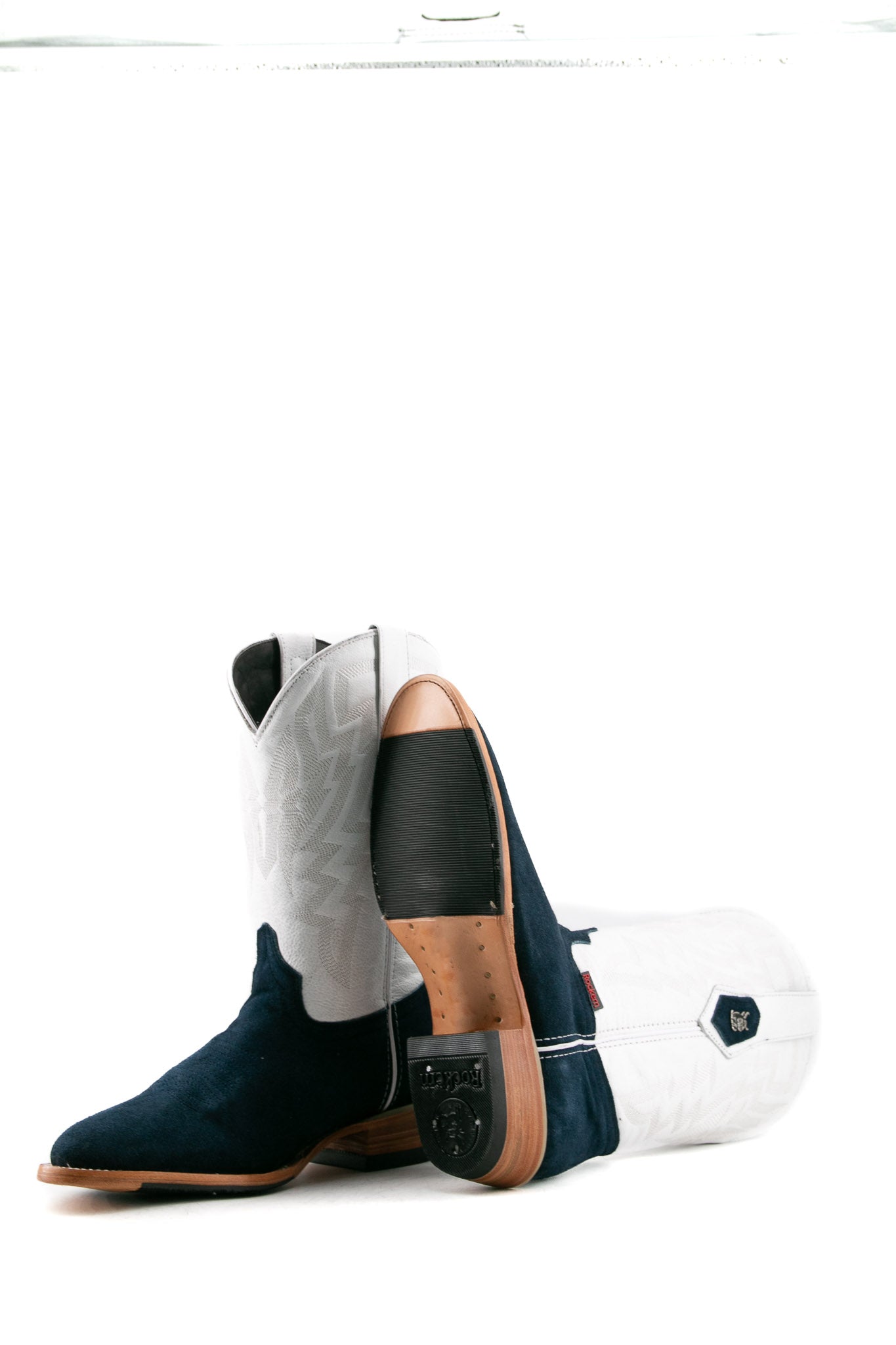 View of the Maverick boots feature a blue suede vamp, white shaft, round toe, sturdy leather sole and half rubber sole, and rubber heel.