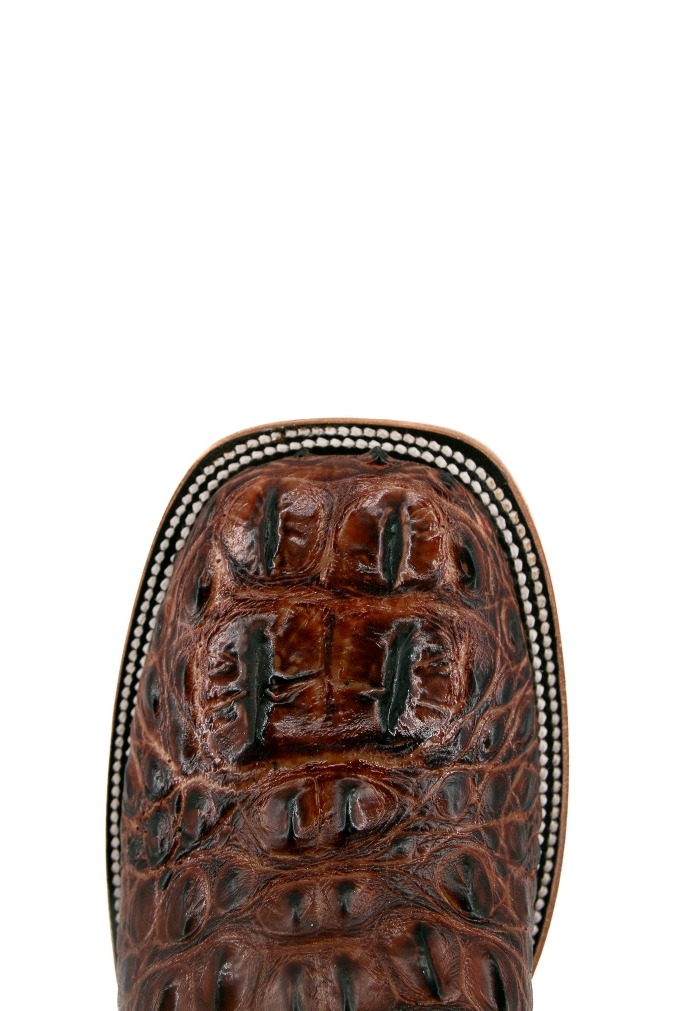 Top-down close-up of the cogñac Caiman Tail Hornback cowboy boot vamp showing the caiman print detail and square toe.