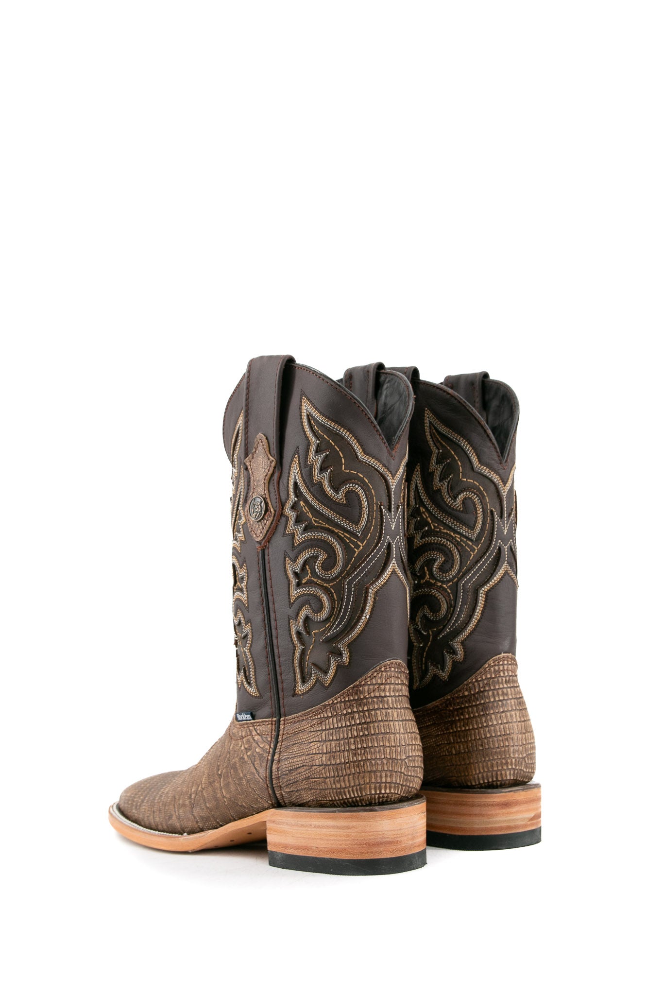 The Lizard Matte cowboy boots feature a square toe, tan lizard print vamp, smooth brown leather shaft with intricate stitching, rubber heel, and Rock'em bull emblem.