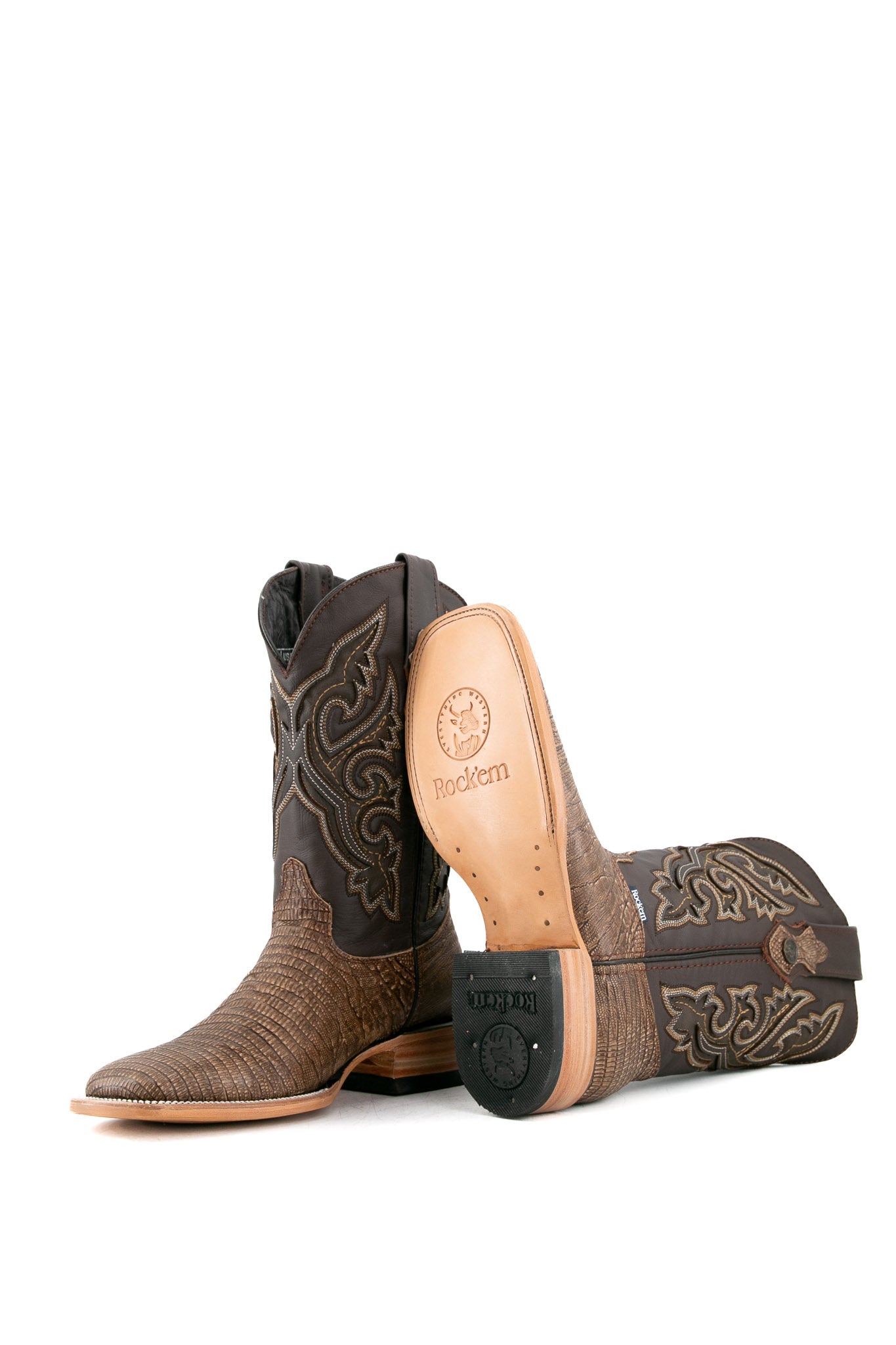 The Lizard Matte cowboy boots feature a square toe, tan lizard print vamp, smooth brown leather shaft with intricate stitching, rubber heel, and Rock'em bull emblem.