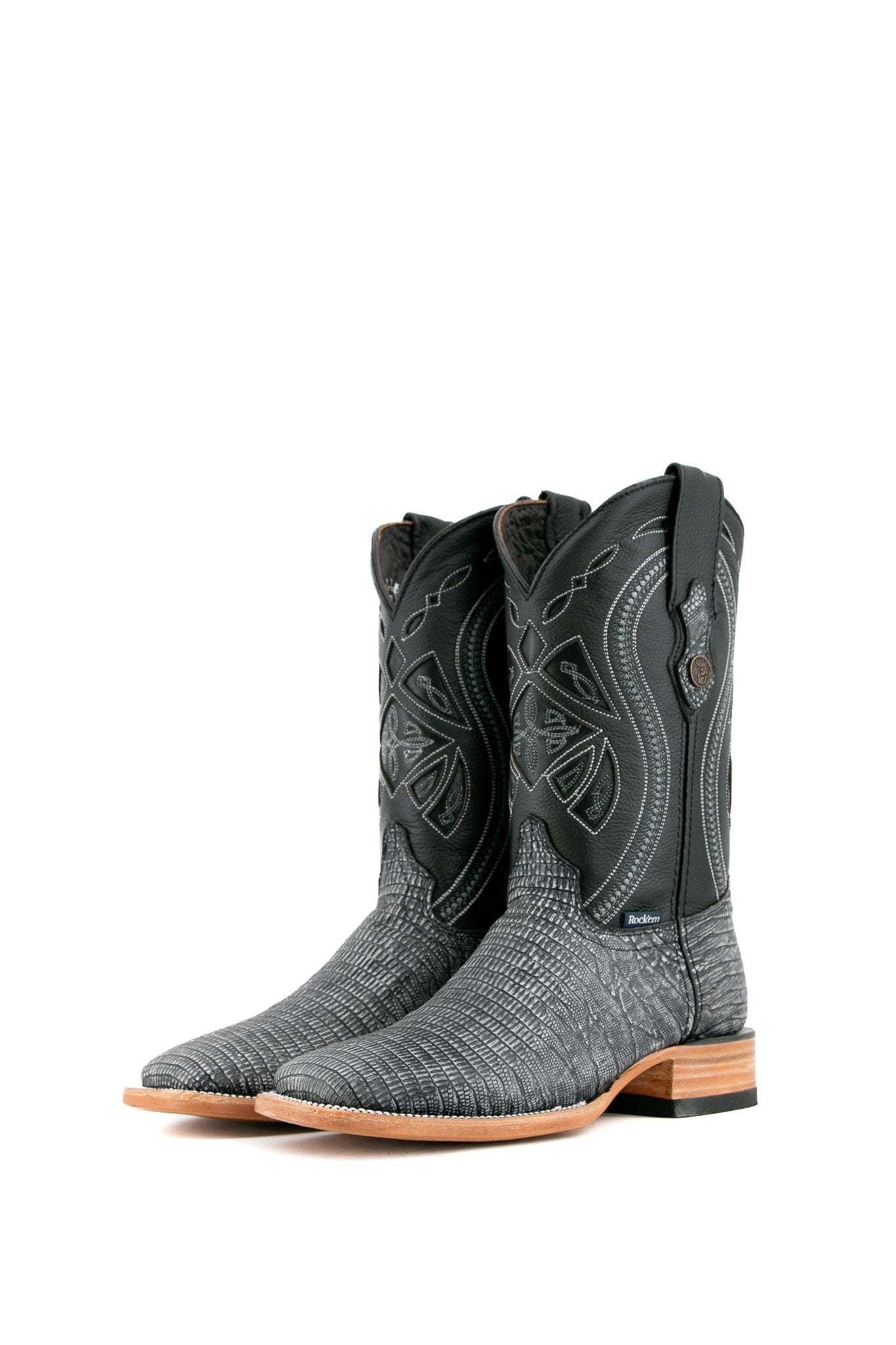 The Lizard Matte cowboy boots feature a square toe, black safari lizard print vamp, smooth black leather shaft with intricate stitching, rubber heel, and Rock'em bull emblem.