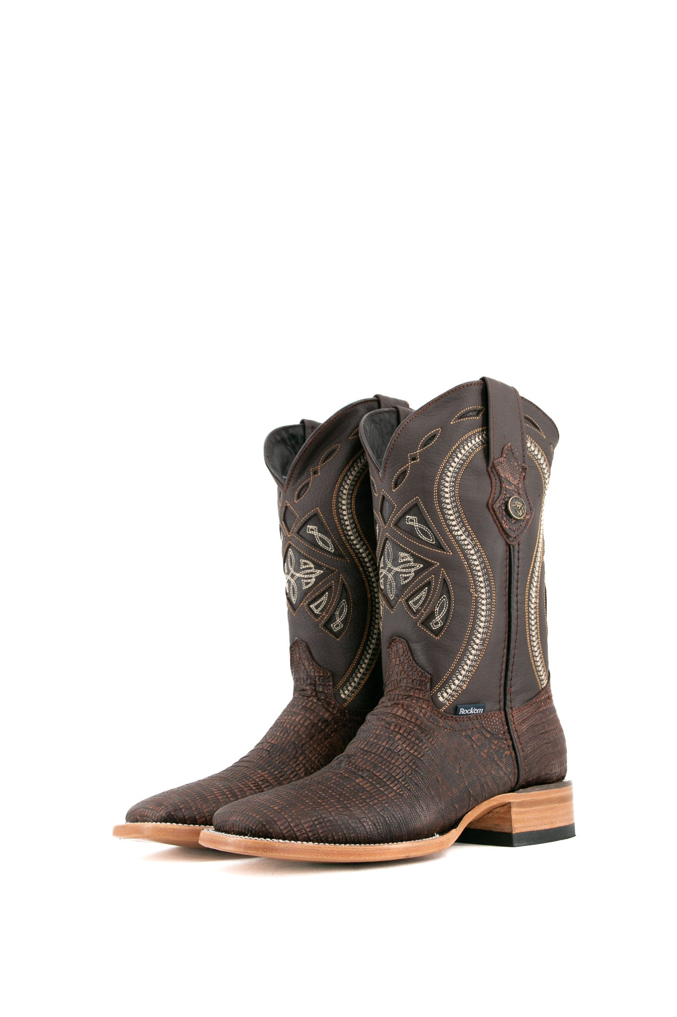 The Lizard Matte cowboy boots feature a square toe, brown lizard print vamp, smooth brown leather shaft with intricate stitching, rubber heel, and Rock'em bull emblem.
