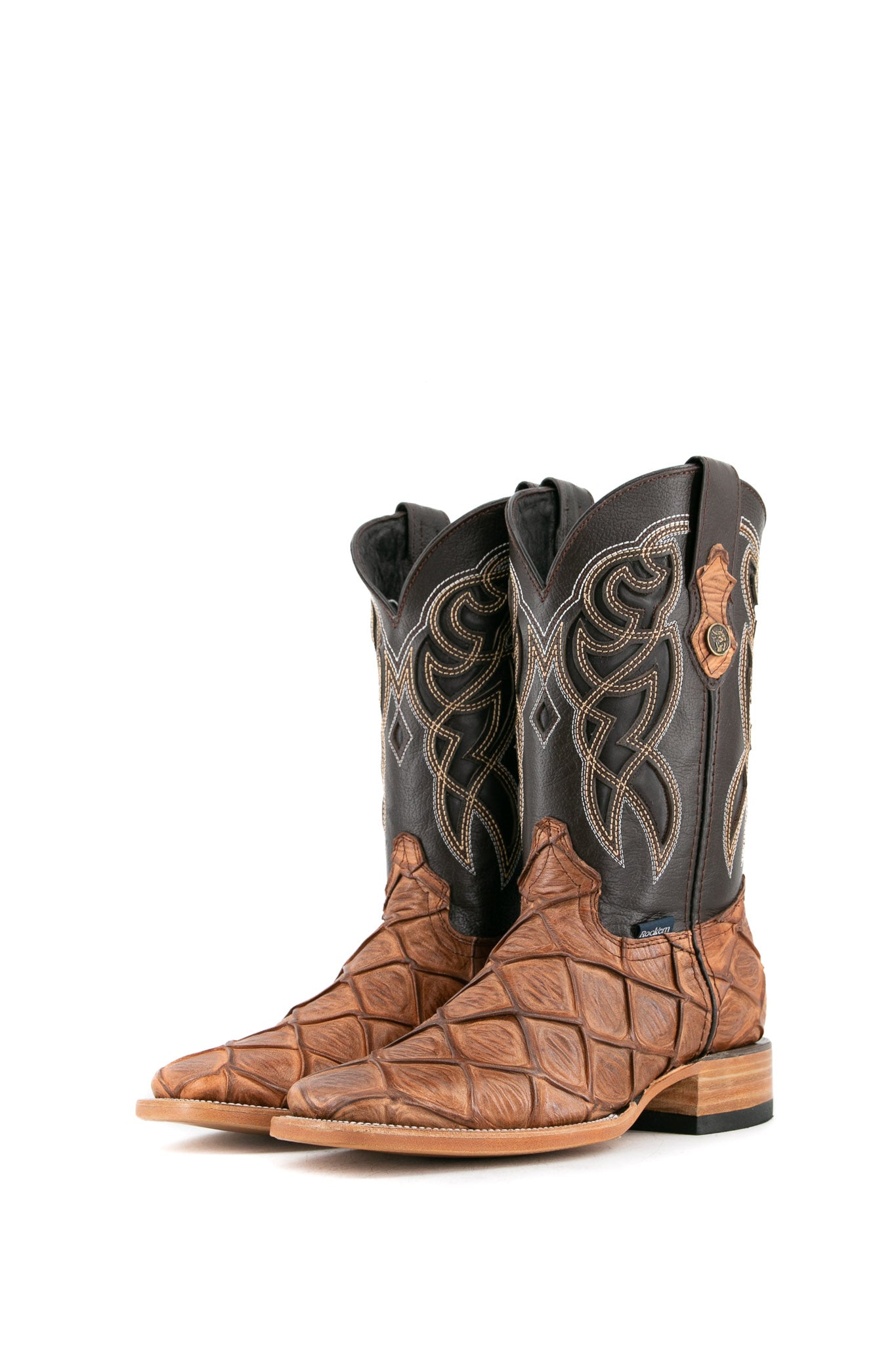 The amber Big Bass Pirarucu cowboy boots are genuine leather, featuring a square toe, tan pirarucu print vamp, brown shaft with white embroidery, rubber heel.