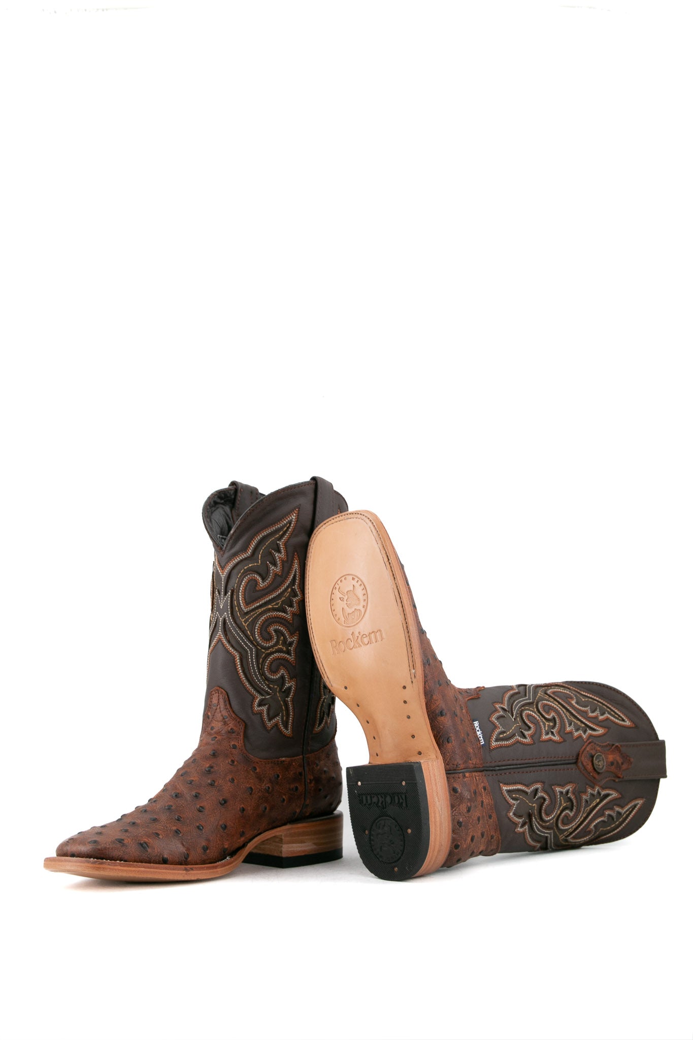 The Ostrich Matte Rustic boots in Rustic Shedron with a square toe, ostrich quill texture, brown leather shaft with brown embroidery, and tan sole.