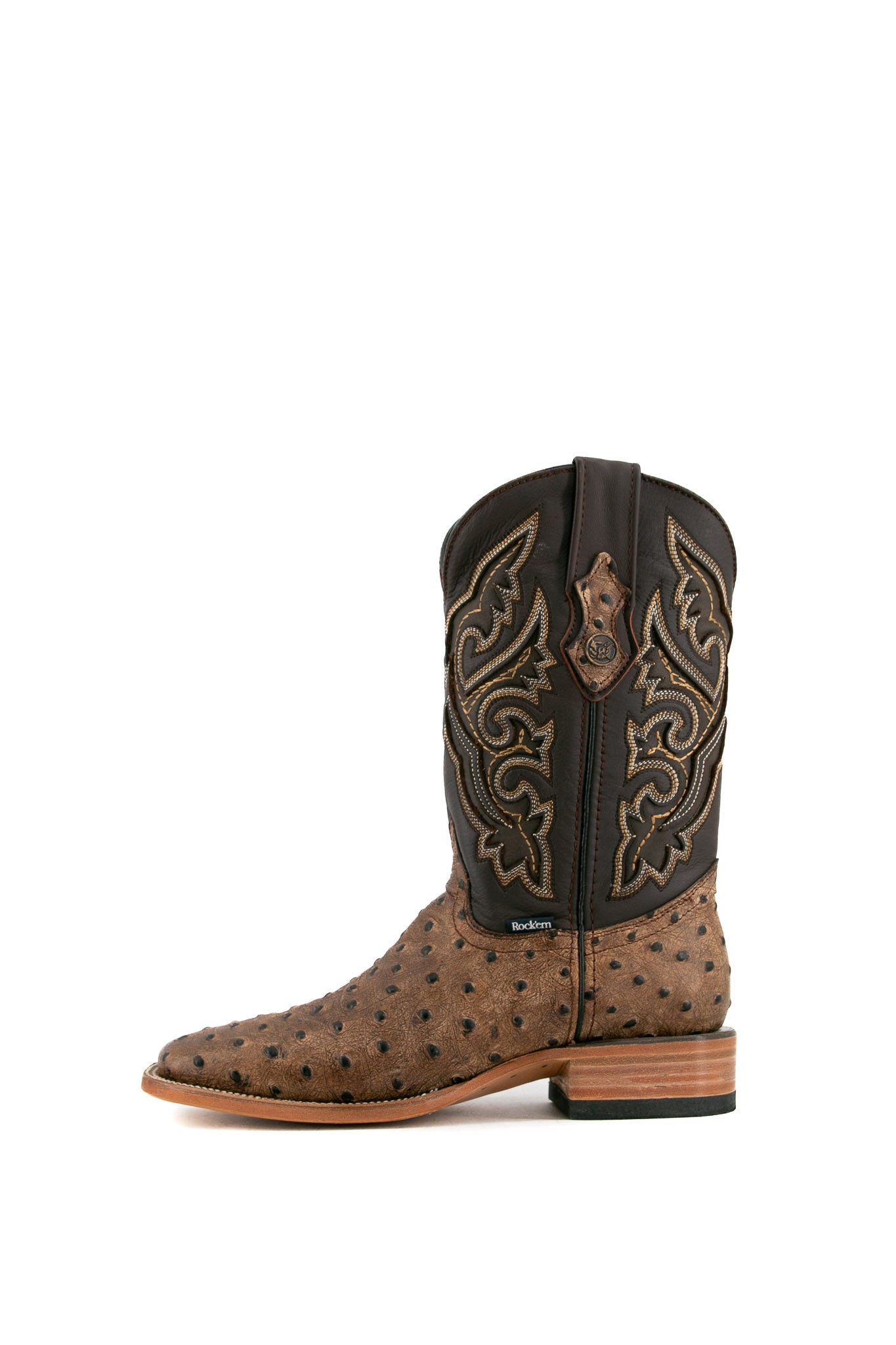 Side view of The Ostrich Matte Rustic boots in saddle brown with a square toe, ostrich quill texture, brown leather shaft with brown embroidery, and stacked heel.