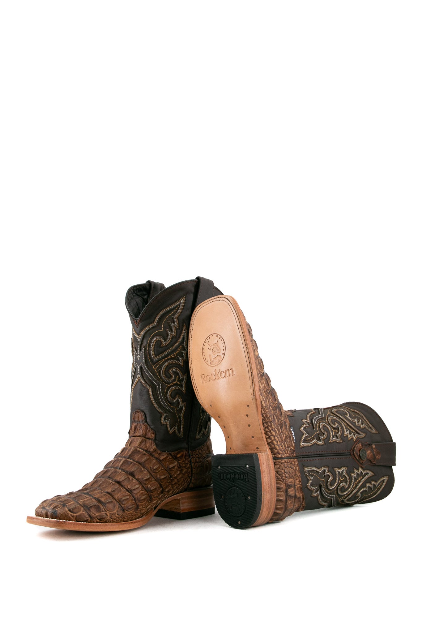 View of rustic honey Giant Caiman Hornback cowboy boots in genuine leather, featuring a square toe, brown caiman print vamp, brown embroidered shaft, tan leather sole and rubber heel.