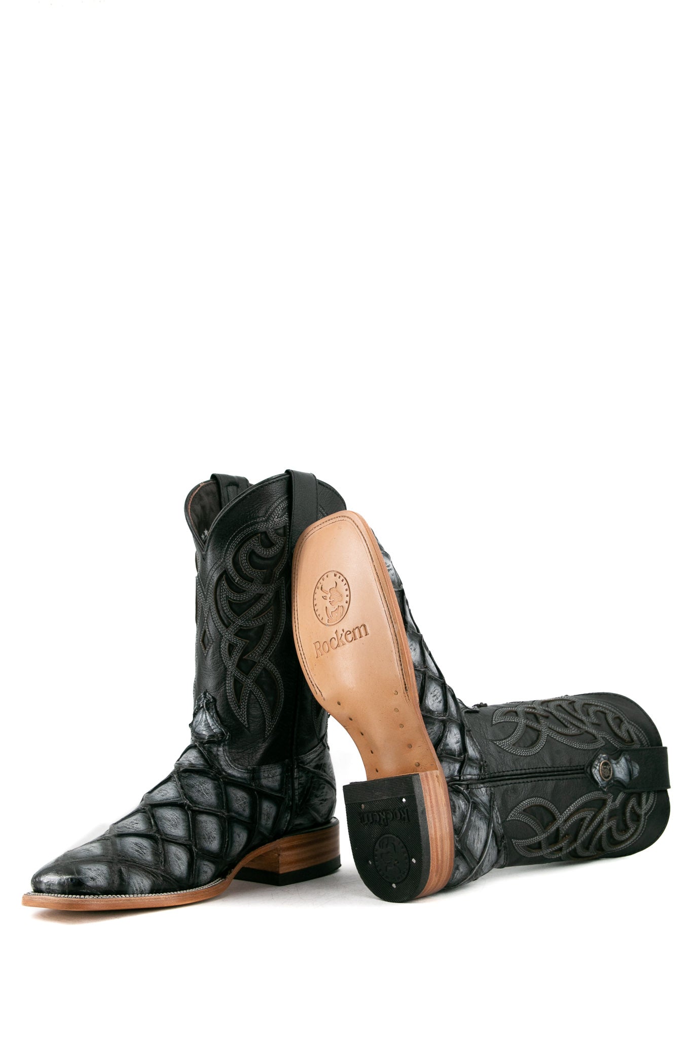View of black safari Big Bass Pirarucu Cowboy Boot features genuine leather, square toe, black and gray pirarucu print vamp, black embroidered shaft, rubber heel, and tan leather sole.