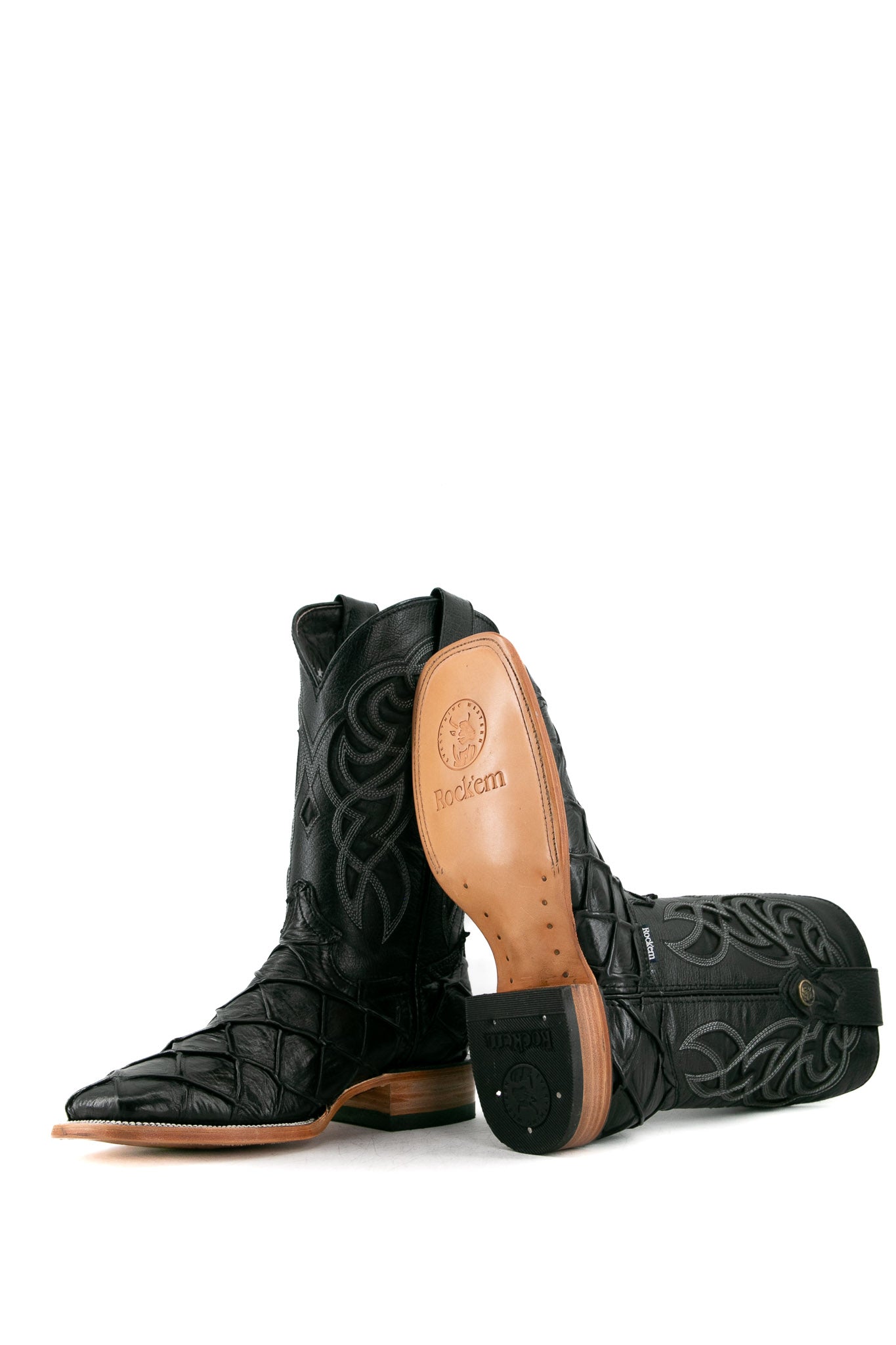 View of black Big Bass Pirarucu Cowboy Boot features genuine leather, square toe, black pirarucu print vamp, black embroidered shaft, rubber heel, and tan sole.