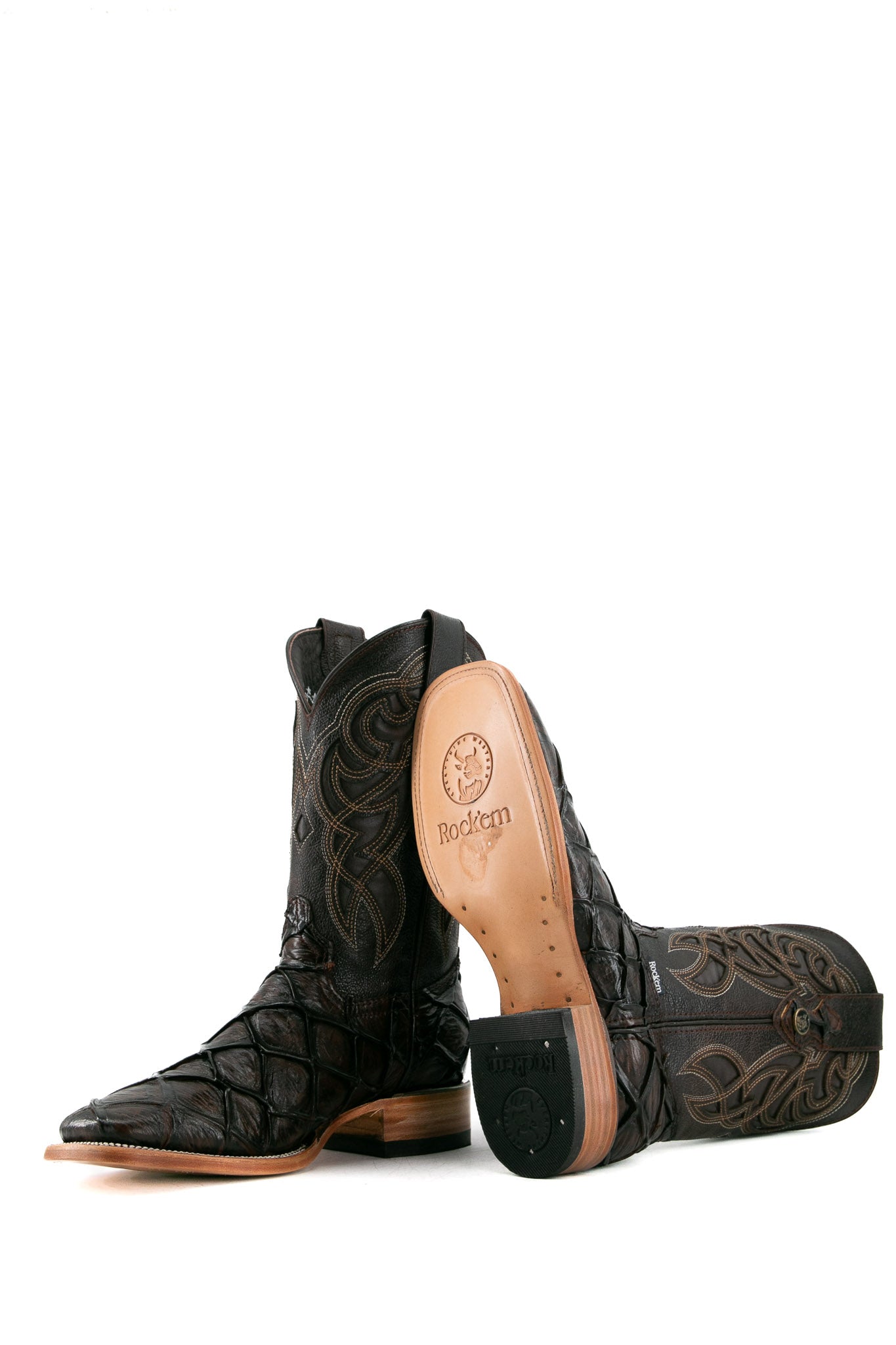 View of the brown shedron Big Bass Pirarucu Cowboy Boot in genuine leather, square toe, brown pirarucu print vamp, brown embroidered shaft, rubber heel, and tan sole.