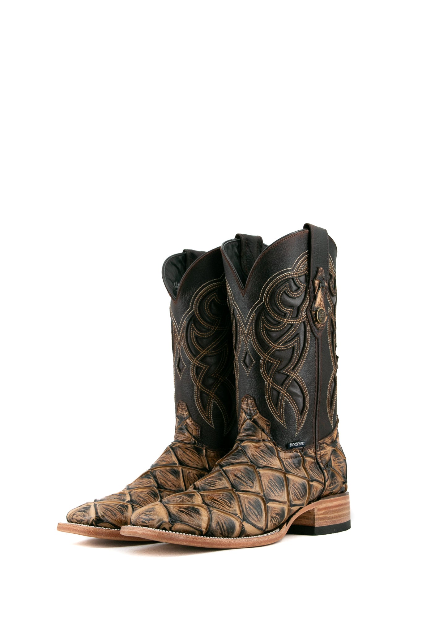 The camel Big Bass Pirarucu Cowboy Boot in genuine leather, square toe, camel pirarucu print vamp, brown embroidered shaft, rubber heel, and tan sole.