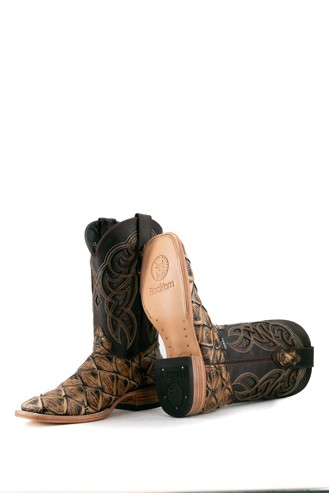 View of the camel Big Bass Pirarucu Cowboy Boot in genuine leather, square toe, camel pirarucu print vamp, brown embroidered shaft, rubber heel, and tan sole.