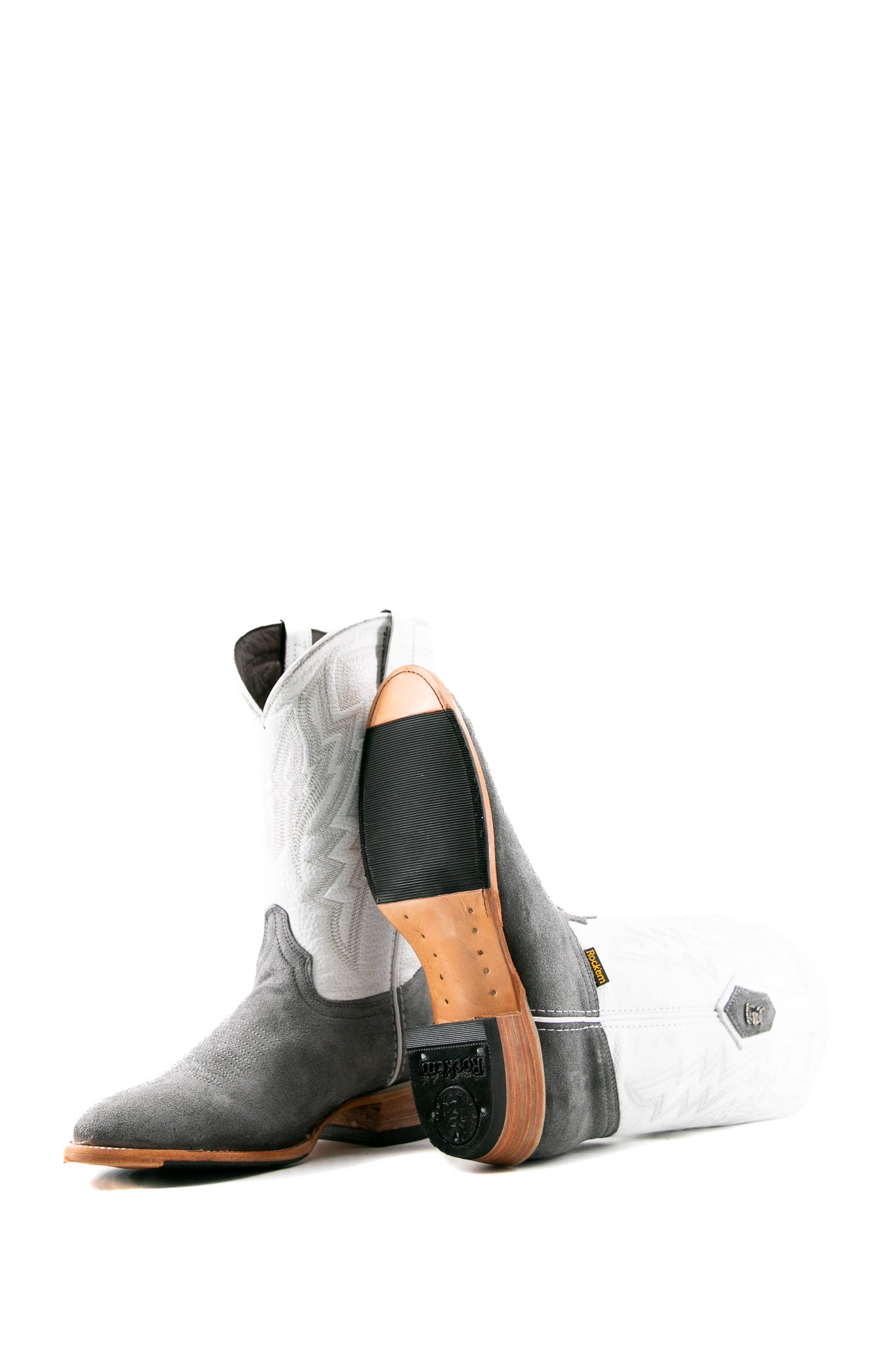View of the Maverick boots feature a blue suede vamp, white shaft, square toe, sturdy leather sole, and rubber heel.