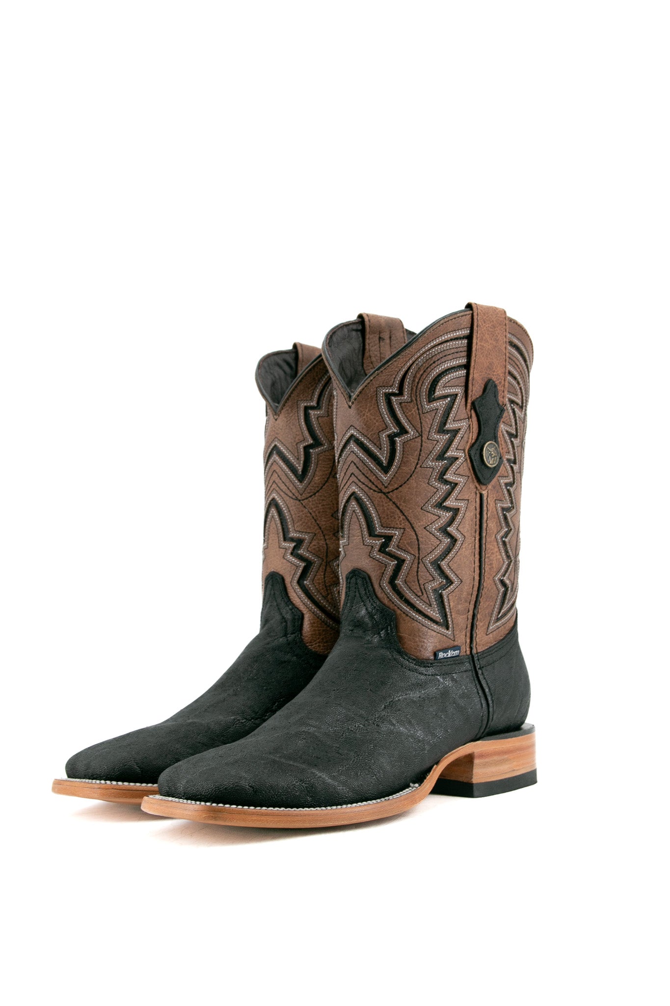 The midnight Rock'em Elephant cowboy boots are crafted from genuine leather, featuring a square toe, elephant print vamp, embroidered shaft, and rubber heel.