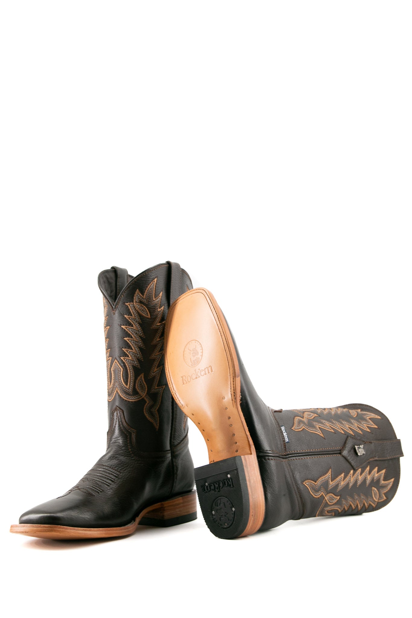 The Heritage Rainbow cowboy boots feature brown leather with intricate stitching and embroidery, a Rock'em bull emblem, durable leather sole, and rubber heel.