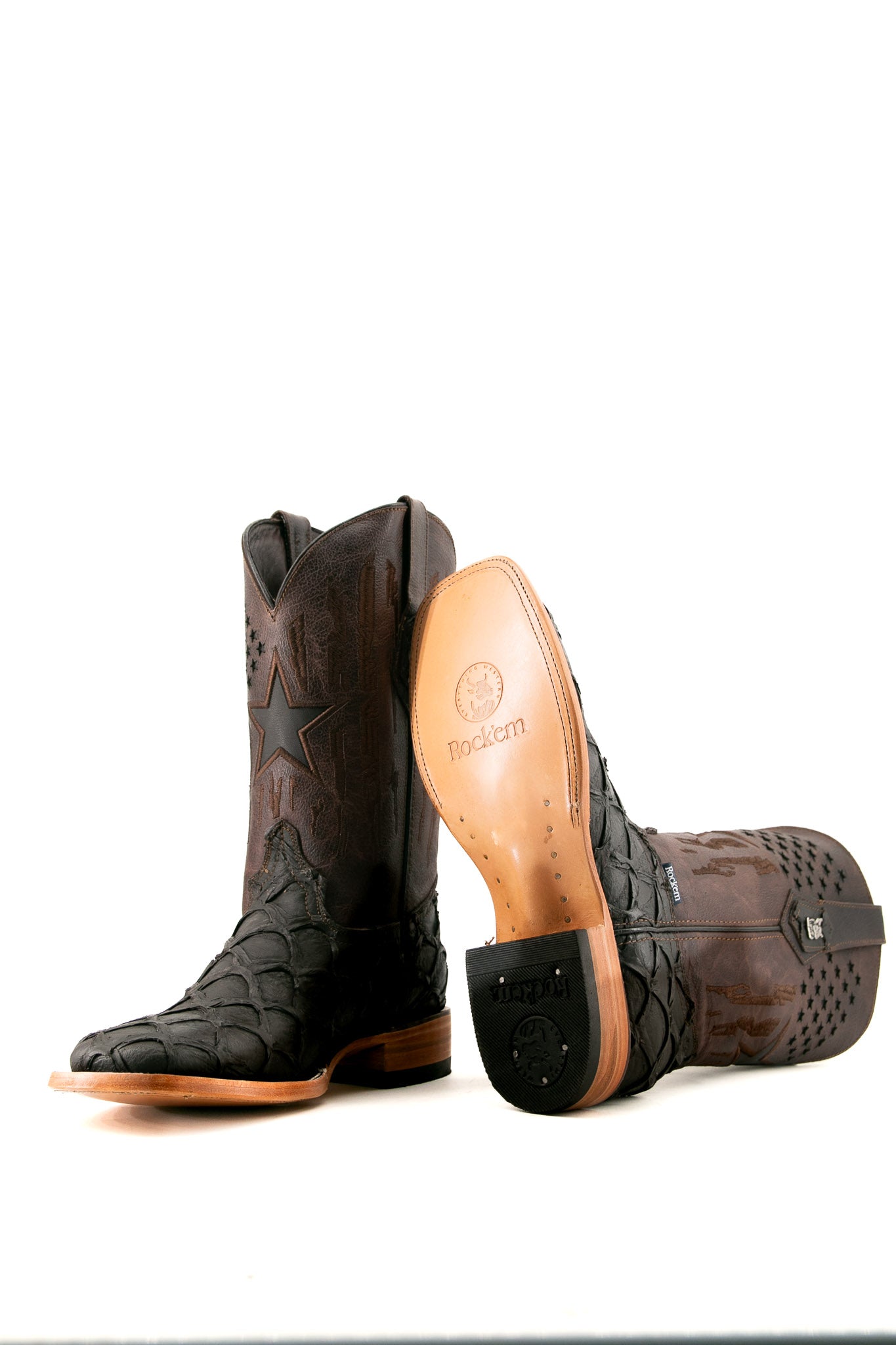 View of the brown Clone Fish Pirarucu Matte cowboy boots with a square toe, brown pirarucu print vamp, star perforations embroidered brown shaft, tan leather sole and a rubber heel.
