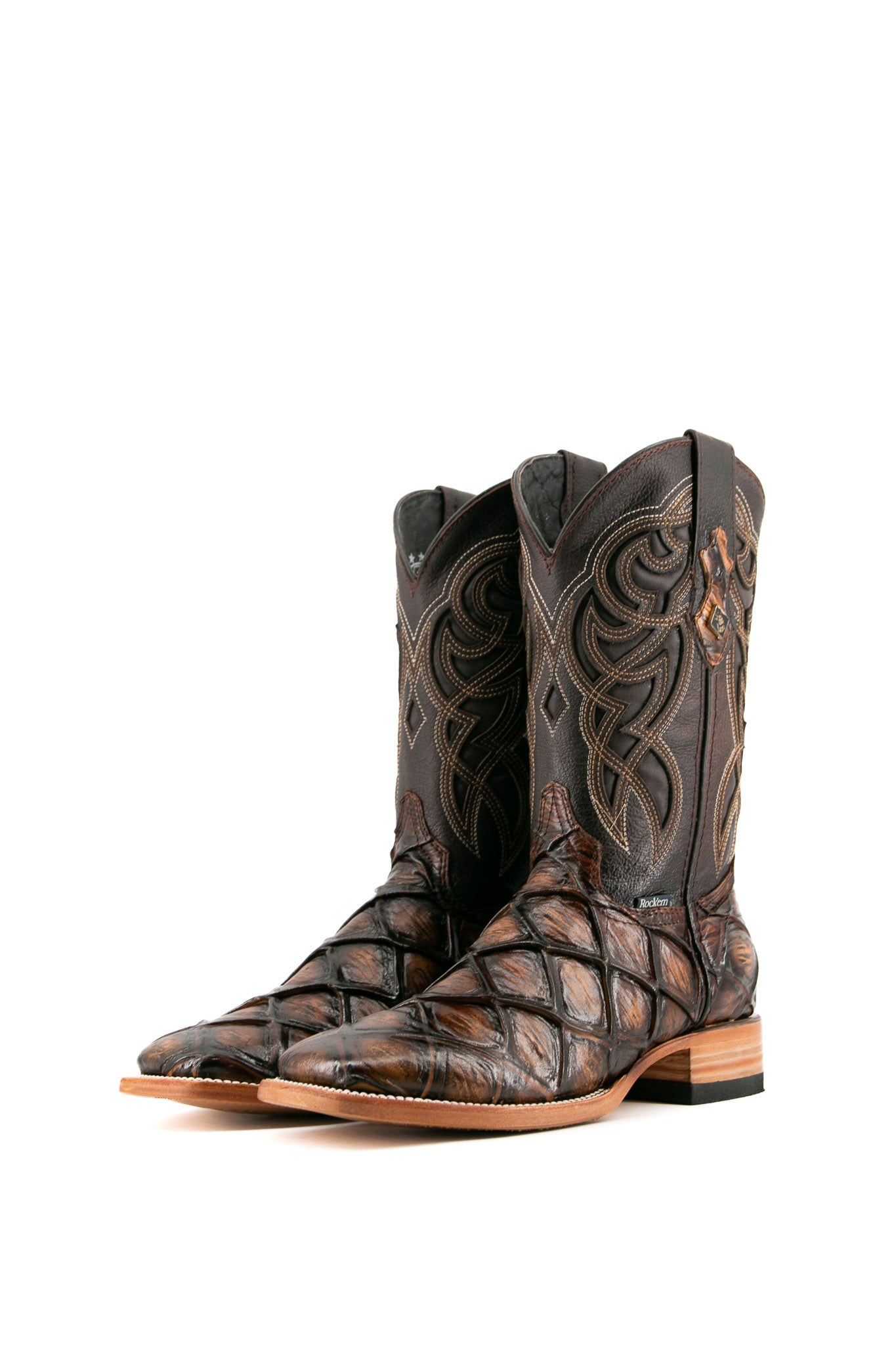 The Honey Big Bass Pirarucu Cowboy Boot features genuine leather, square toe, honey pirarucu print vamp, brown embroidered shaft, rubber heel, and tan sole.