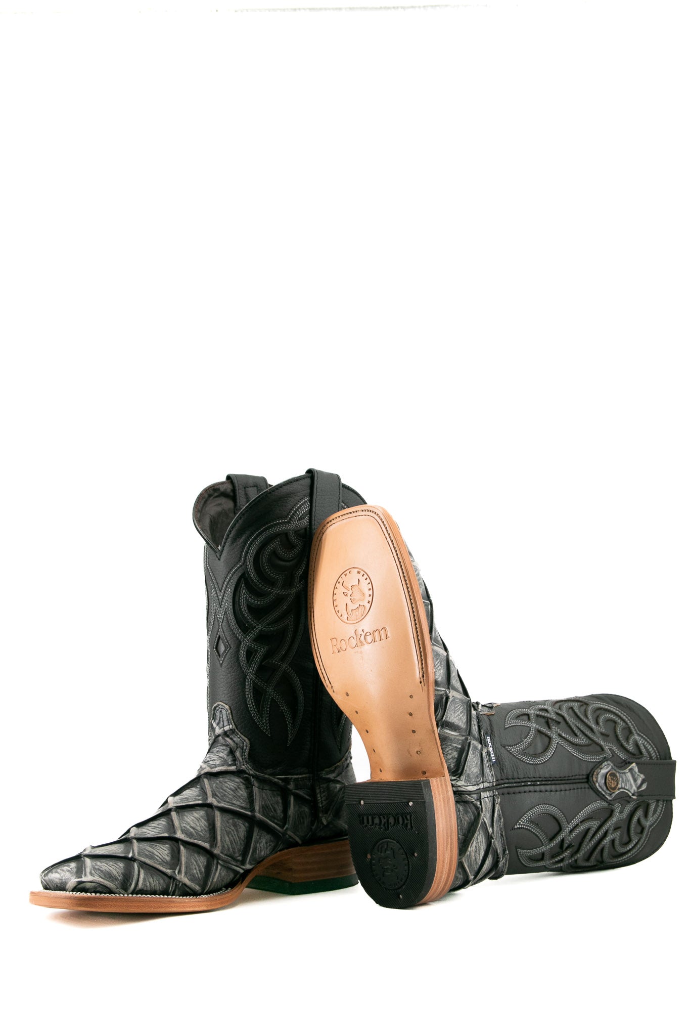 View of granite safari Big Bass Pirarucu Cowboy Boot in genuine leather, square toe, gray pirarucu print vamp, black embroidered shaft, rubber heel, and tan sole.