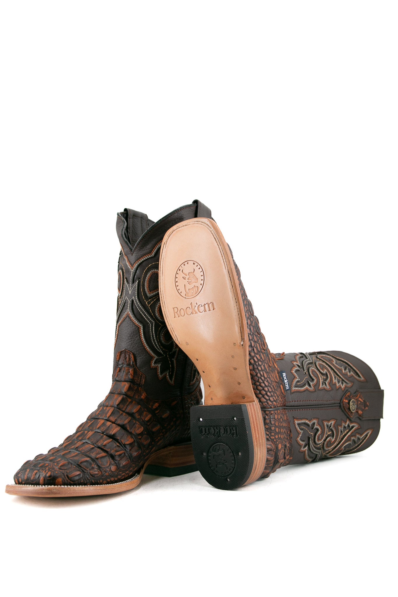 View of rustic shedron Giant Caiman Hornback cowboy boots in genuine leather, featuring a square toe, shedron caiman print vamp, brown embroidered shaft, tan leather sole, and rubber heel.