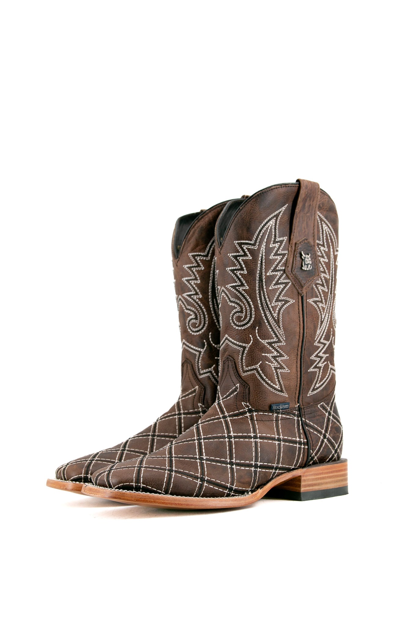 The paja Roca Patchwork Cowboy Boot in genuine leather, square toe, brown roca patchwork print vamp, brown embroidered shaft, rubber heel, and tan sole.