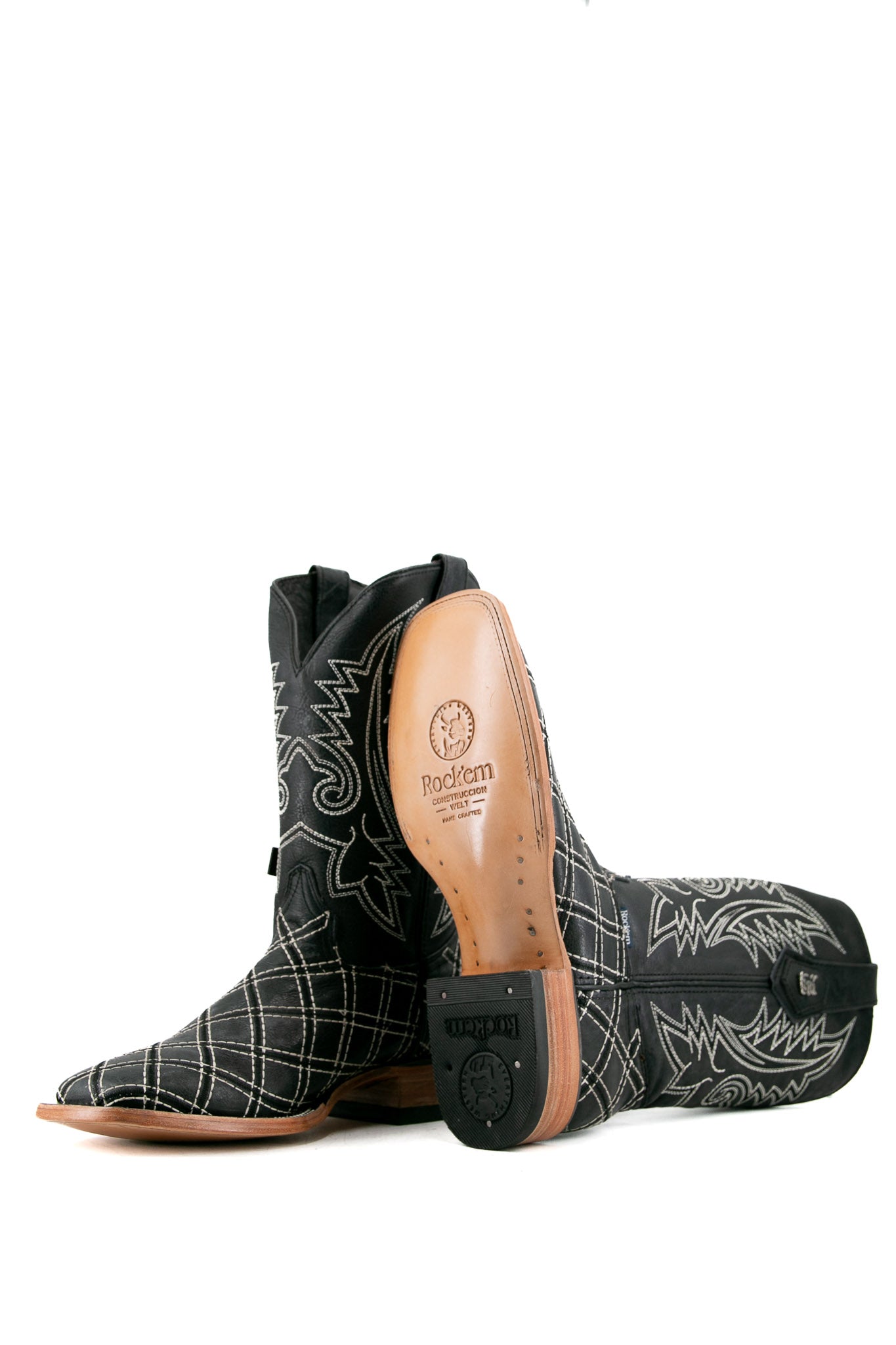 View of negro Roca Patchwork Cowboy Boot in genuine leather, square toe, negro roca patchwork print vamp, negro embroidered shaft, rubber heel, and tan sole.