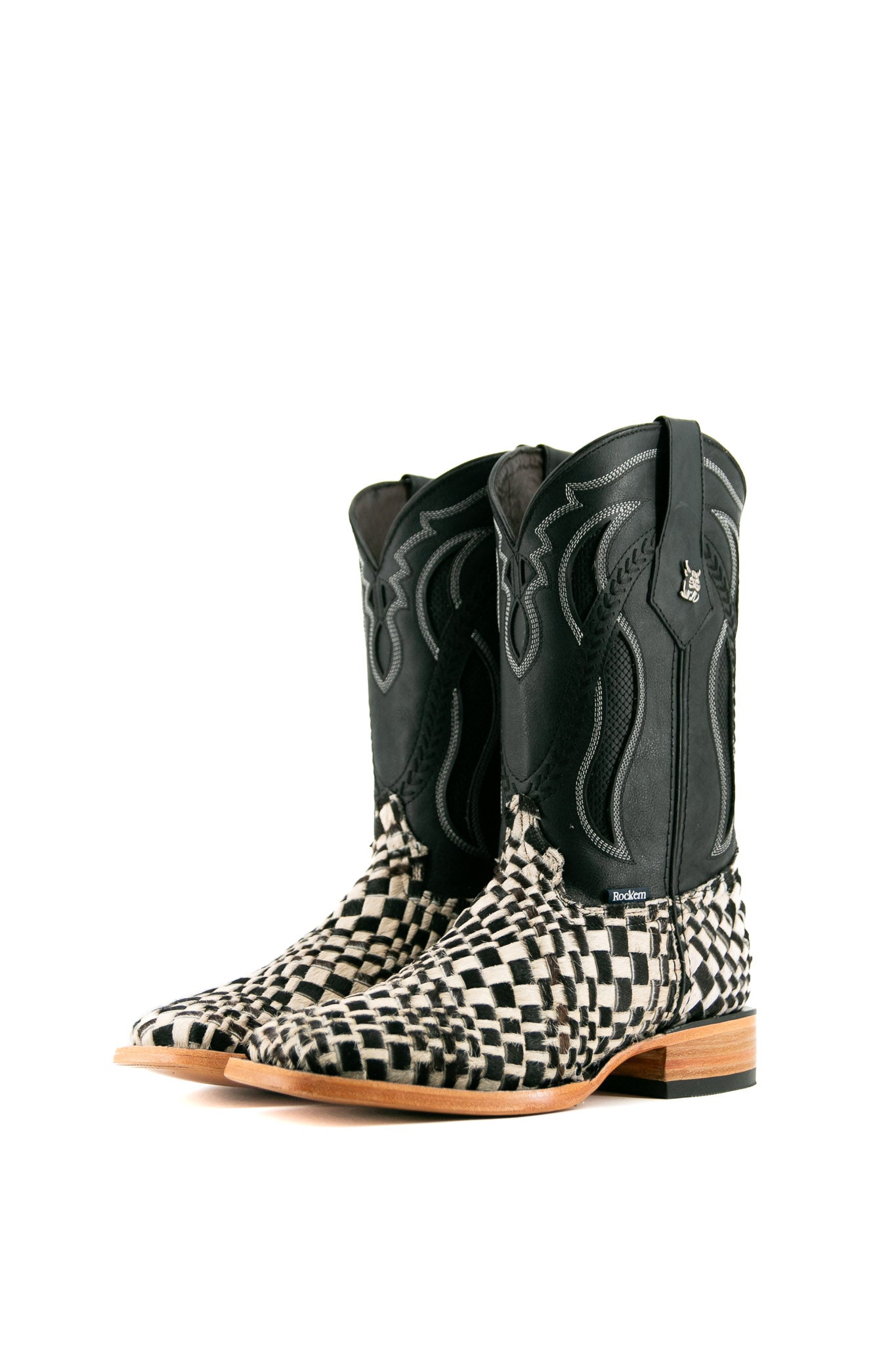 Rock'em Woven Cowhide boots feature a handwoven black & white vamp, black embroidered shaft, square toe, and a leather sole with a rubber heel.