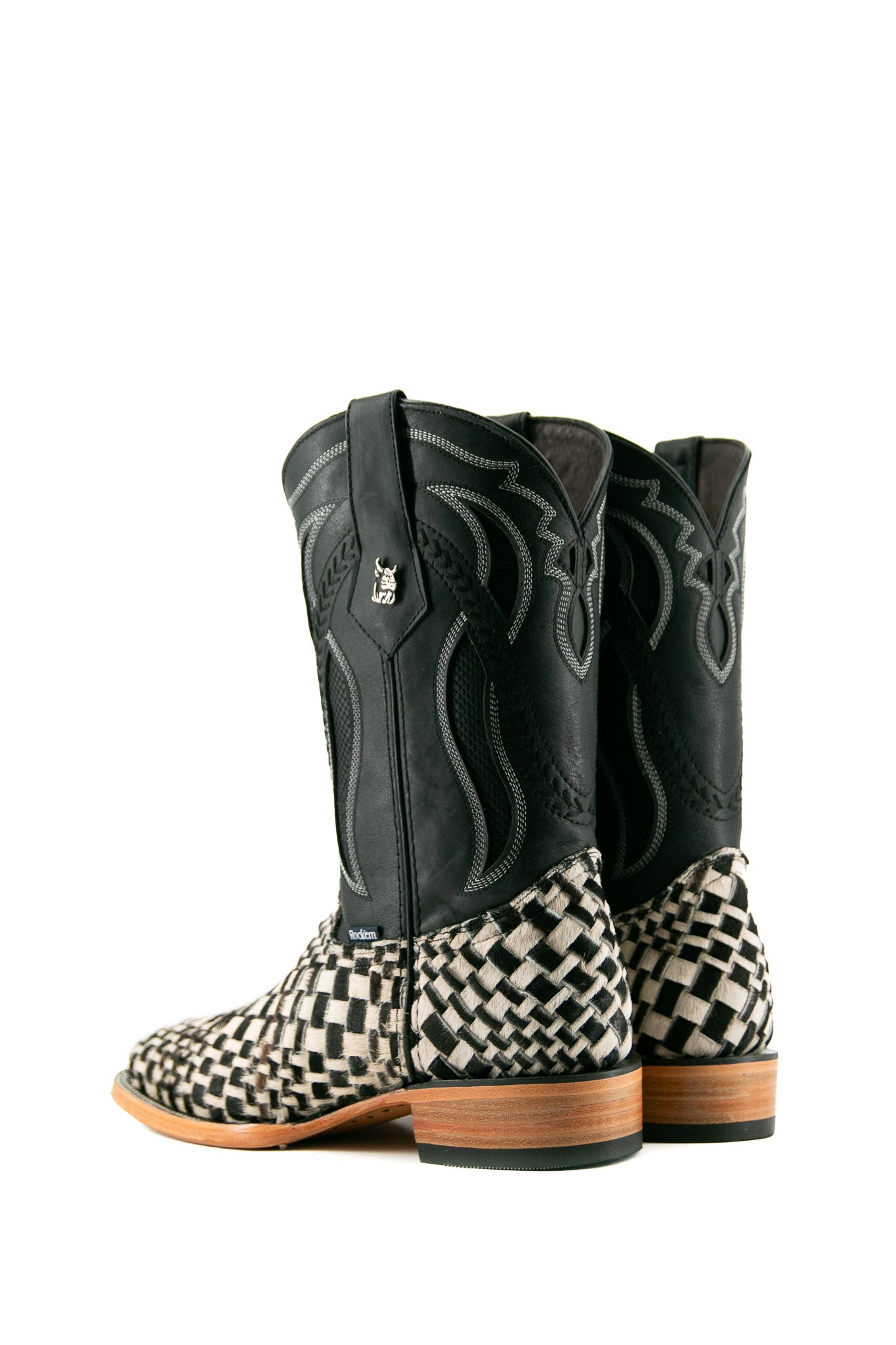 Rock'em Woven Cowhide boots feature a handwoven black & white vamp, black embroidered shaft, square toe, and a leather sole with a rubber heel.