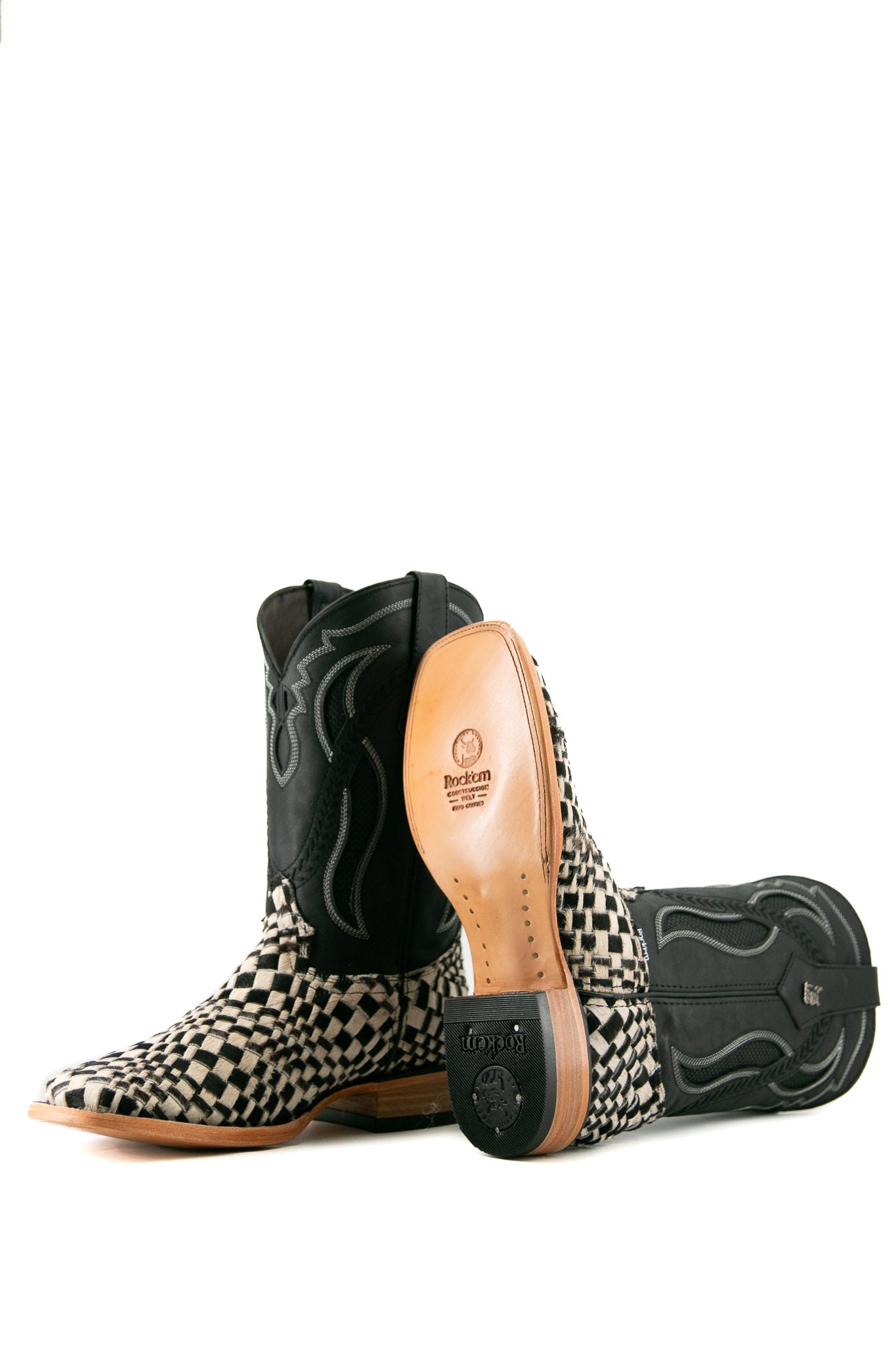 Rock'em Woven Cowhide boots feature a handwoven black & white vamp, black embroidered shaft, square toe, and a leather sole with a rubber heel.