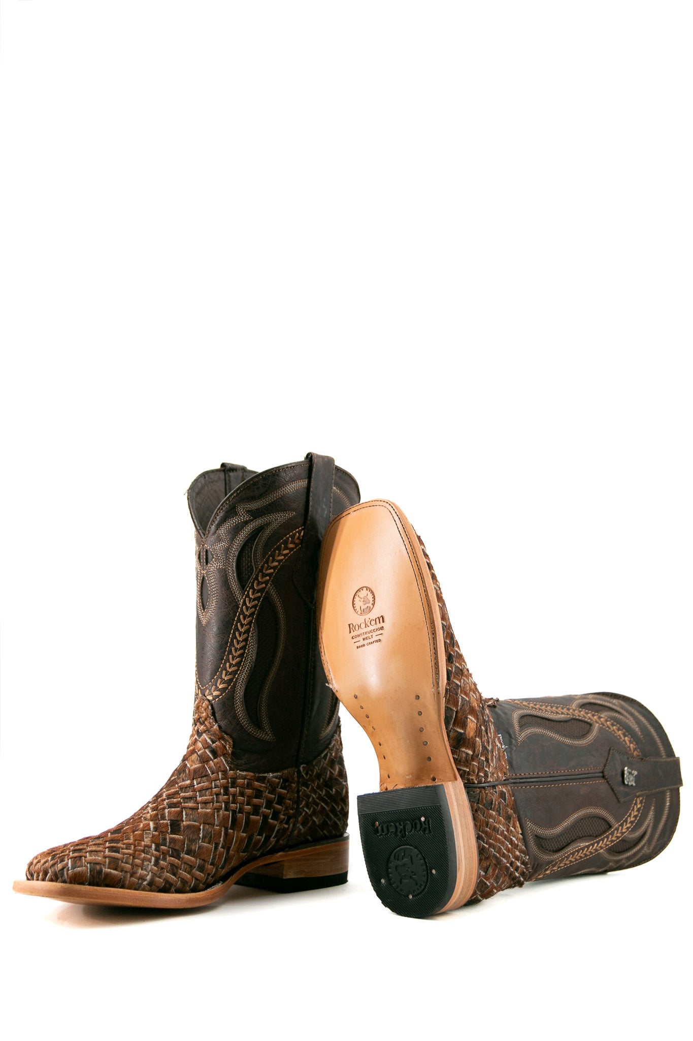 Rock'em Woven Cowhide boots feature a handwoven brown & black vamp, dark brown embroidered shaft, square toe, and a leather sole with a rubber heel.