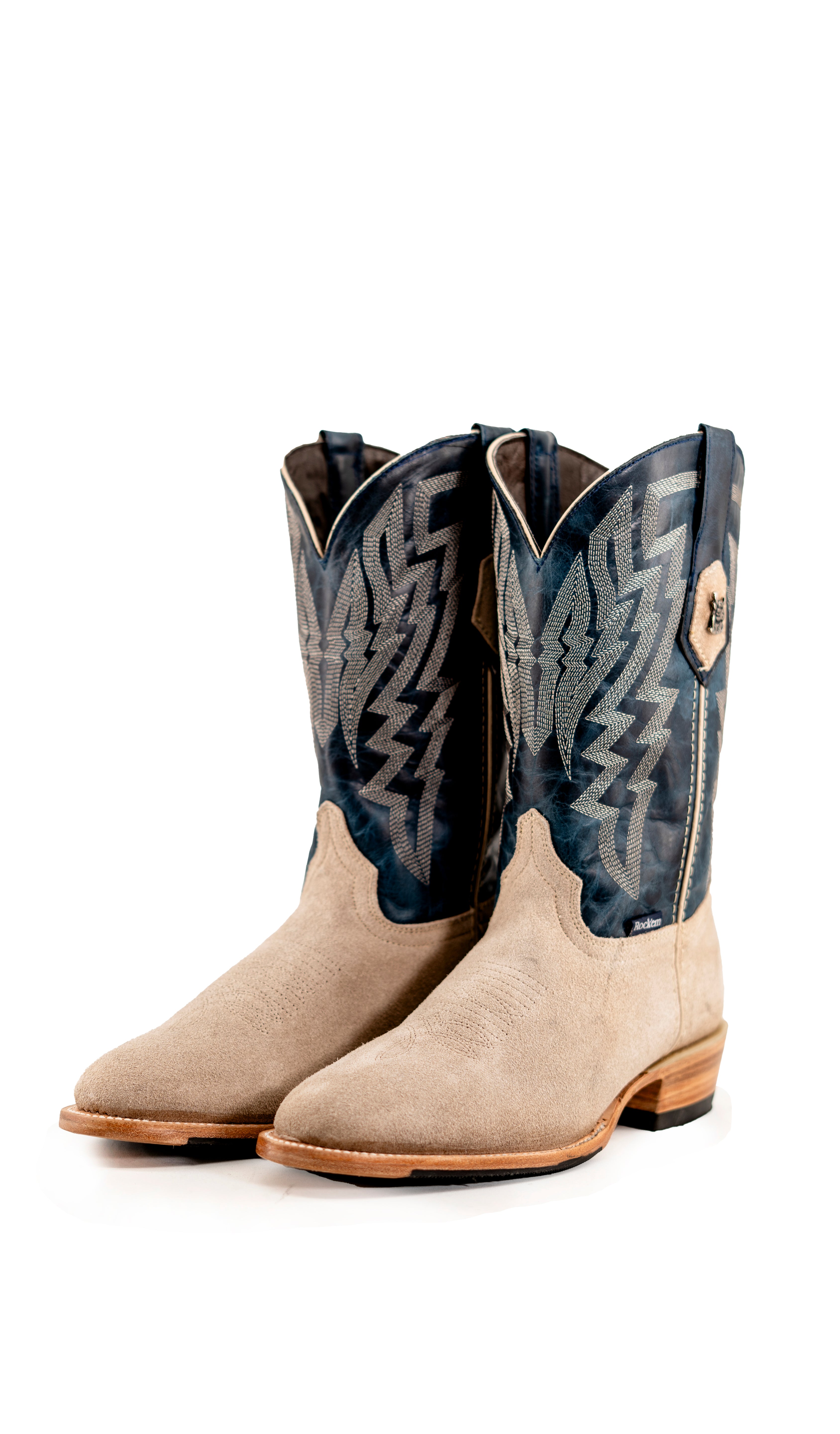 The Maverick boots feature a sand suede vamp, blue shaft, round toe, sturdy leather sole, and rubber heel.