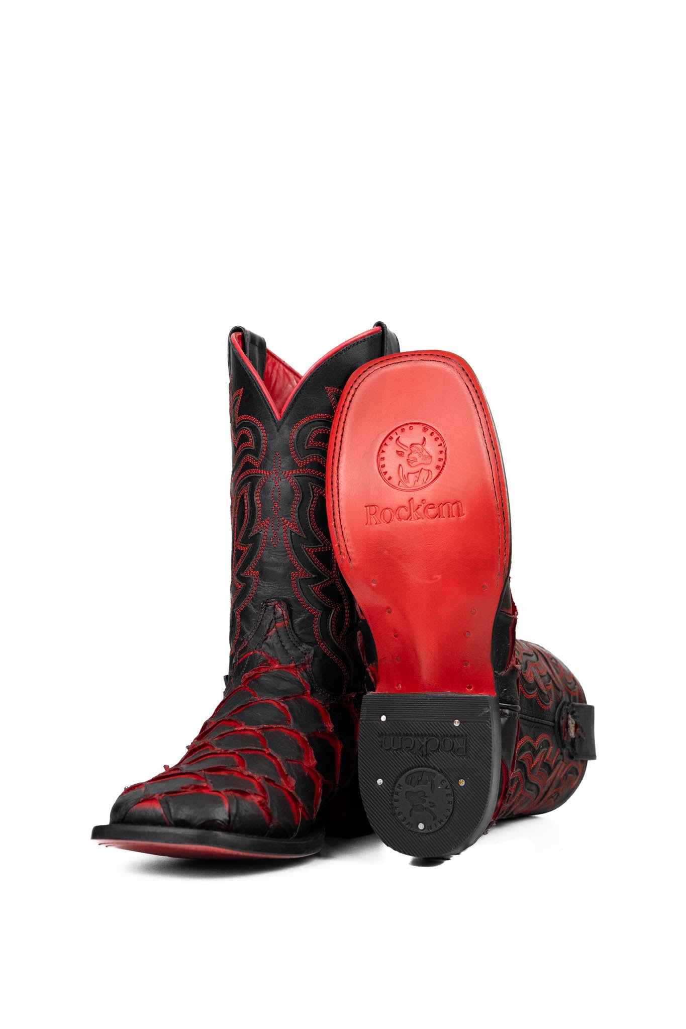 View of the Bruce Jumbo Fish boot features a red and black Pirarucu fish print vamp, a black leather shaft with red embroidery, a square toe, and red sole.
