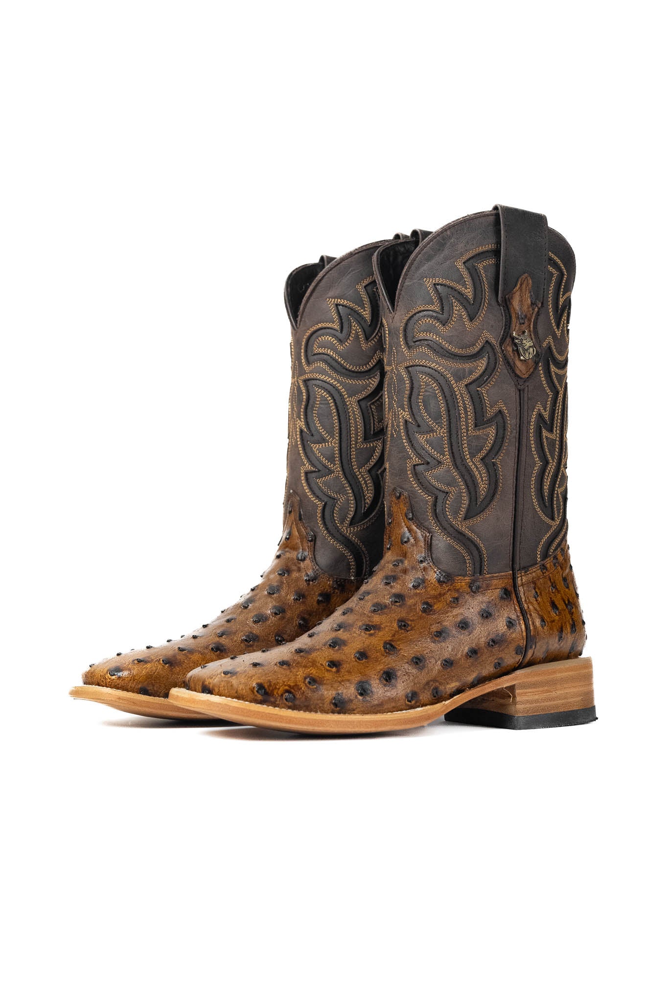 The Ostrich Clone boots have a bumpy brown vamp, a dark brown shaft with flame-like inlays, a square toe, and a sturdy leather sole with a rubber heel.