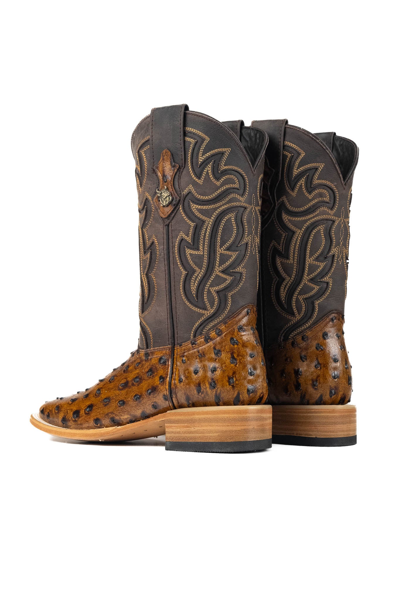 The Ostrich Clone boots have a bumpy brown vamp, a dark brown shaft with flame-like inlays, a square toe, and a sturdy leather sole with a rubber heel.