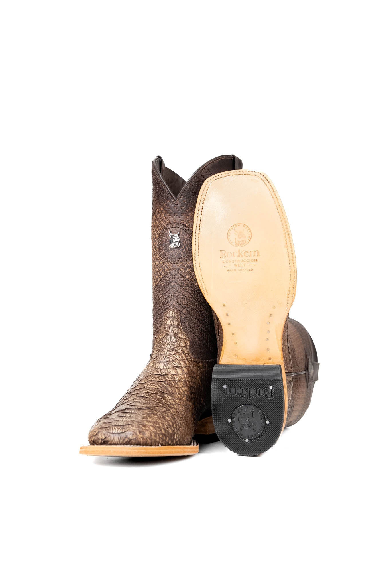 View of the Andersen Python Exotic cowboy boots are genuine leather, featuring a square toe, tan python print vamp, brown shaft with tan embroidery, rubber heel, and a leather sole.