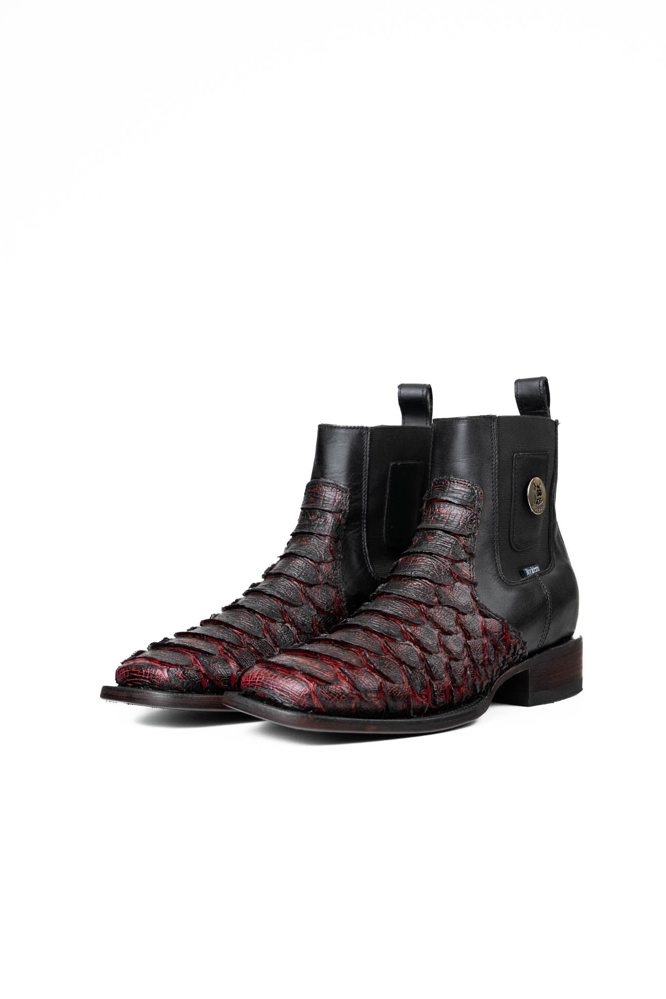 The Rock'em clan python boots in blackcherry are genuine leather. Featuring a square toe, black and red python print vamp, rubber heel, and a leather sole.