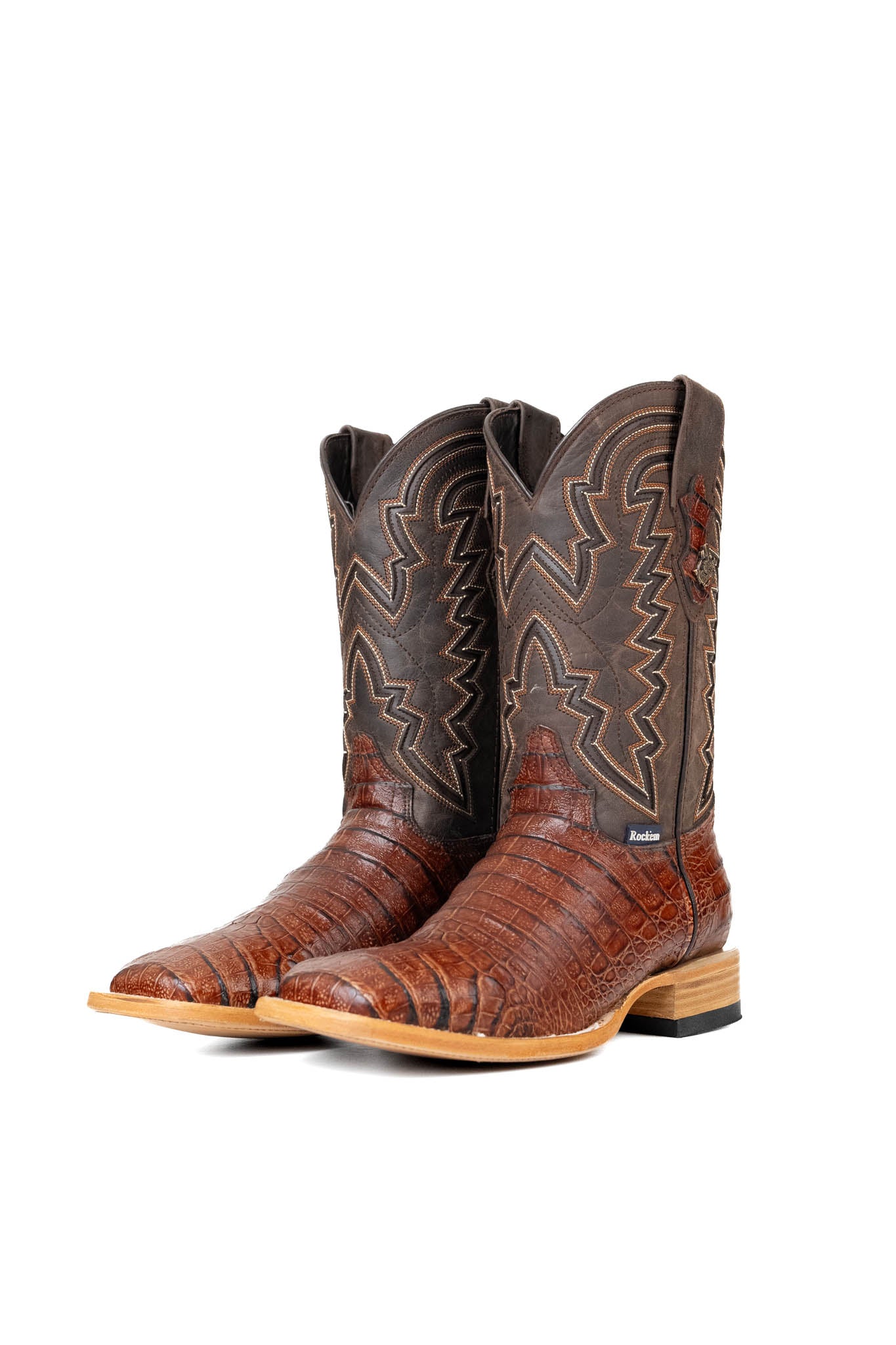 Side view of the Bruce Belly Caiman Cowboy Boots in cognac are made of genuine leather with a round toe, a cognac color belly caiman print vamp, brown embroidered shaft, and leather sole.