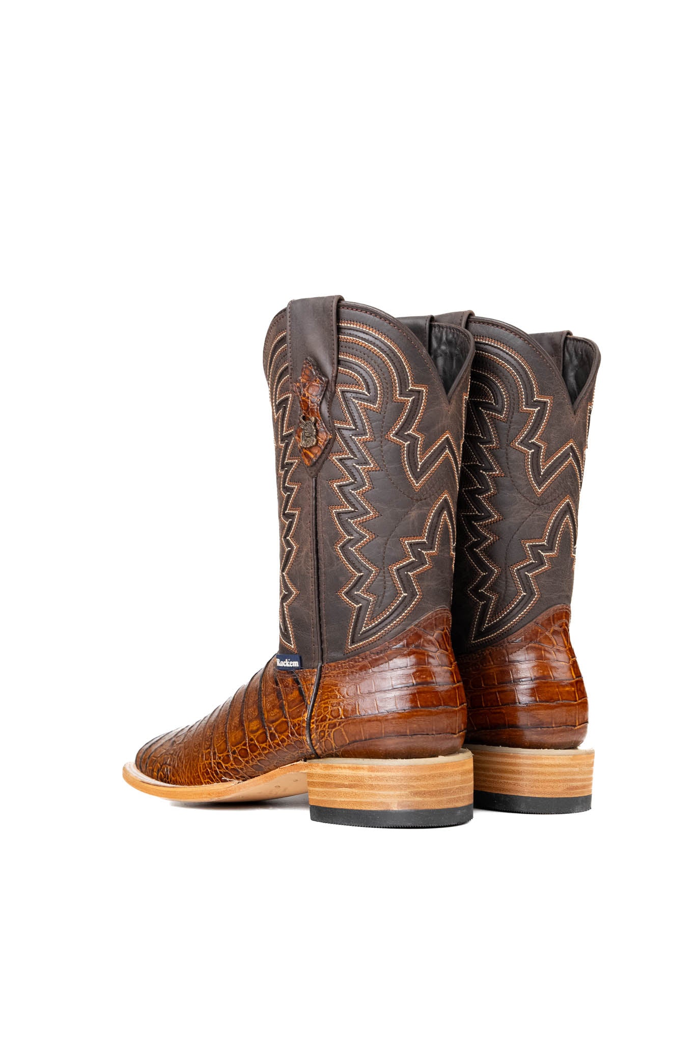 Back view of the Bruce Belly Caiman Cowboy Boots in honey are made of genuine leather with a round toe, a honey color belly caiman print vamp, brown embroidered shaft, and leather sole.