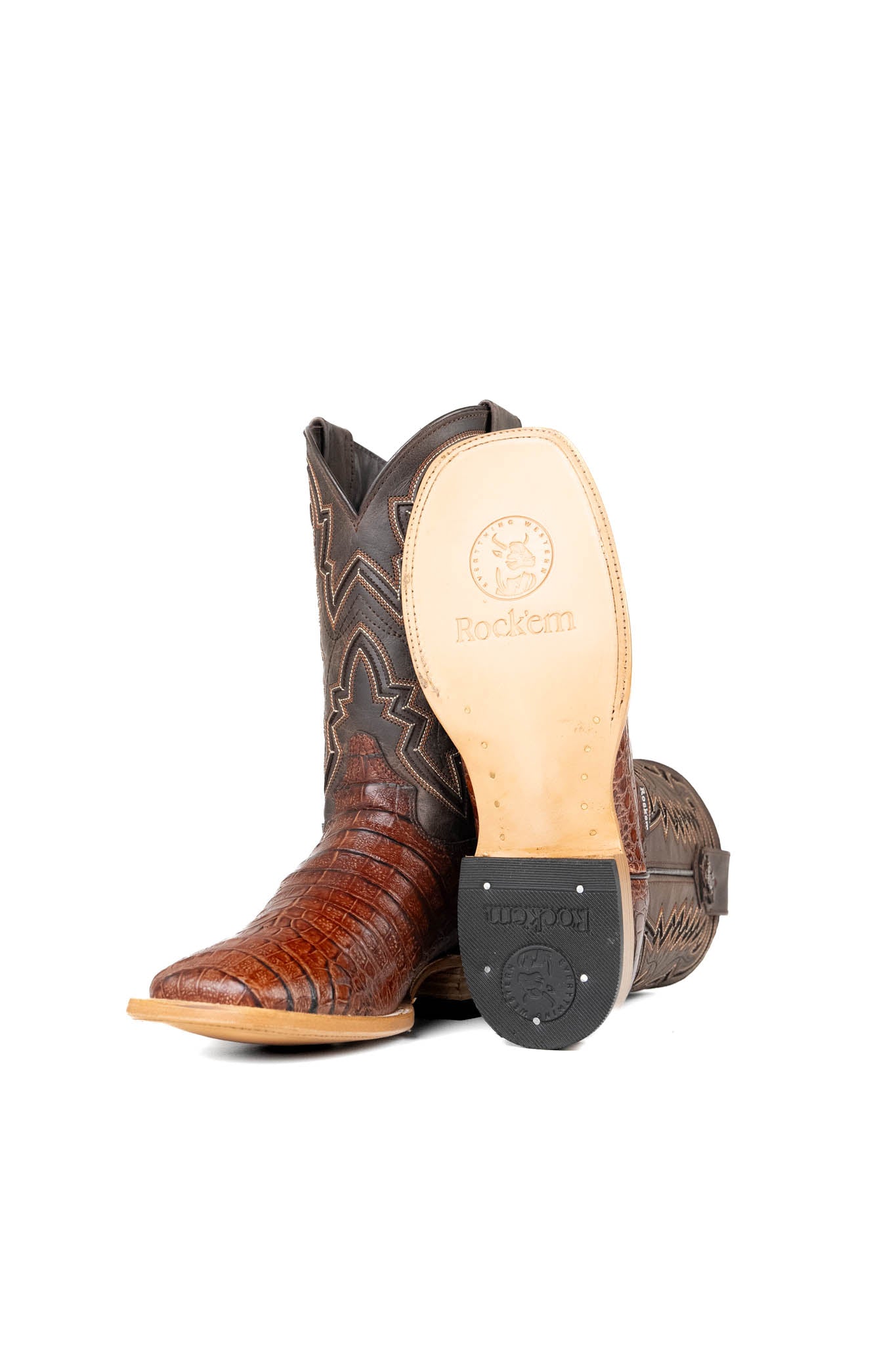View of the Bruce Belly Caiman Cowboy Boots in cognac are made of genuine leather with a round toe, a cognac color belly caiman print vamp, brown embroidered shaft, and leather sole.