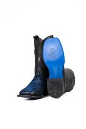 View of the Python Exotic Cowboy Boots in Blue/Black. Made from genuine leather, blue and black python-print vamp, square toe, and an embroidered shaft. Finished with a durable rubber heel and a blue sole.