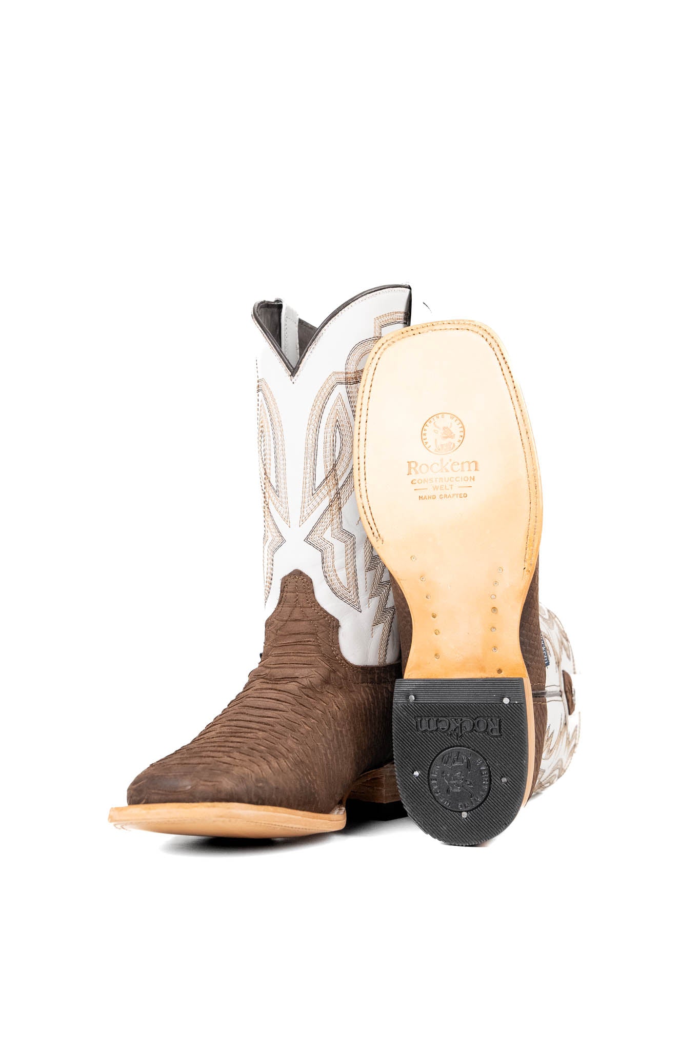 View of the Renegate Python boot in chocolate featuring a brown pirarucu fish print vamp, white leather shaft with embroidery, a square toe, and leather sole.