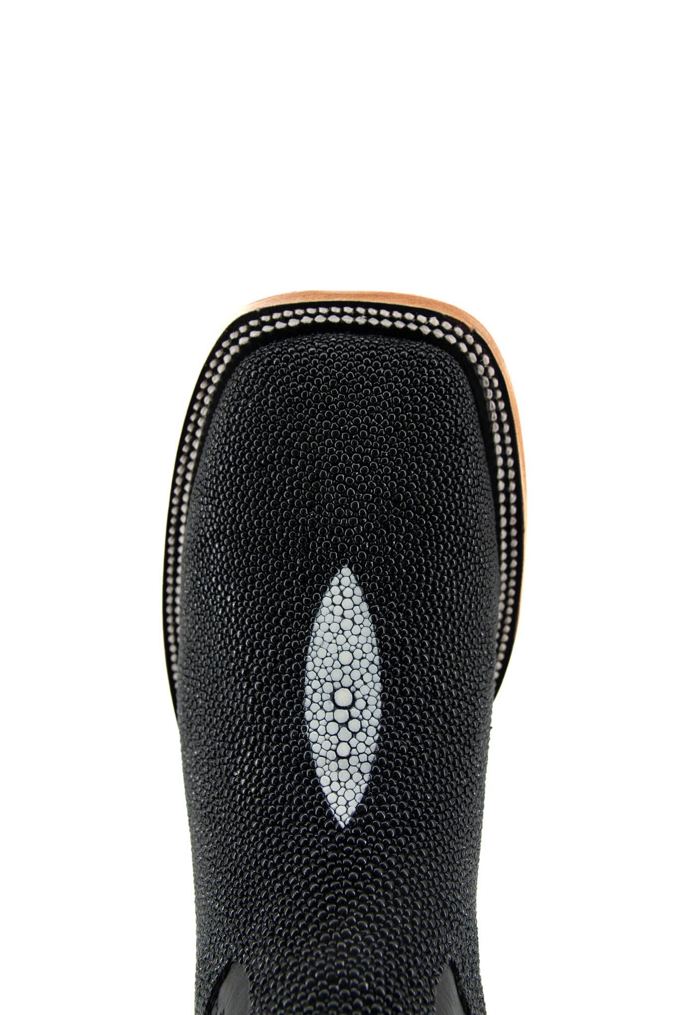 Top-down close-up of black Barnet cowboy boot vamp, showcasing the black stingray vamp with a pebbled texture and a white diamond-shaped marking, double stitching and square toe.
