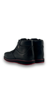 Back view of the onyx red bottom are leather botines, featuring a square toe, woven-textured panel across the vamp, and rubber heel.