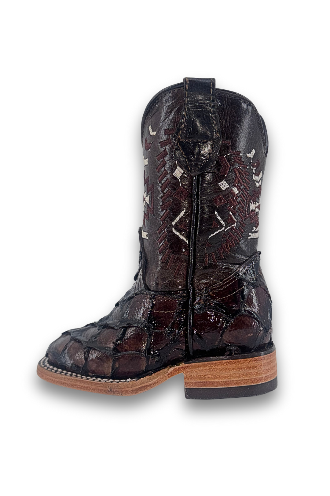 Side view of the clone fish pirarucu Aztec kids boot in all brown, featuring a square toe, pirarucu vamp, embroider shaft, leather sole, and rubber heel.