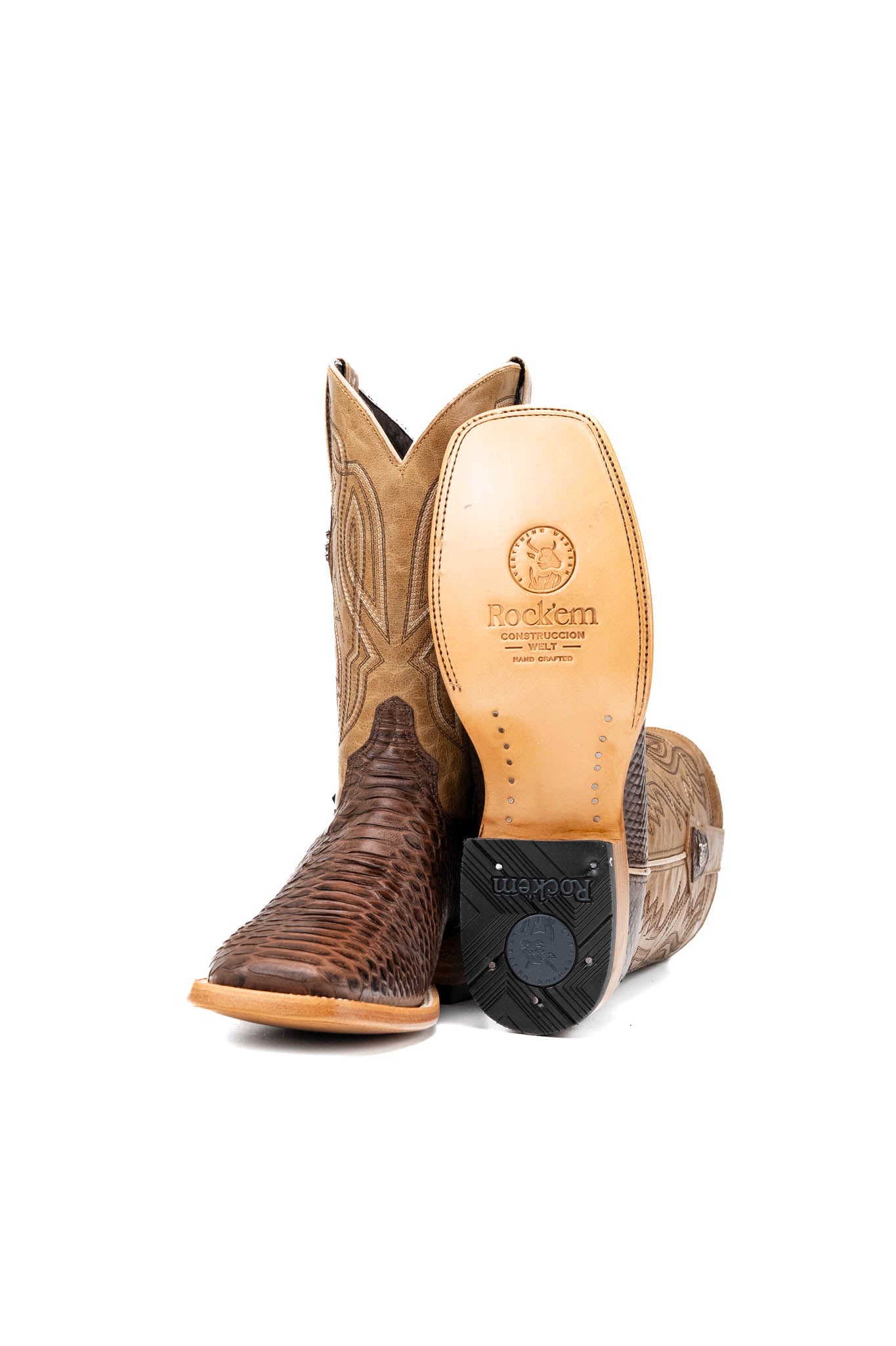 View of the renegade python cowboy boot in brown showcasing the leather sole and rubber heel. 